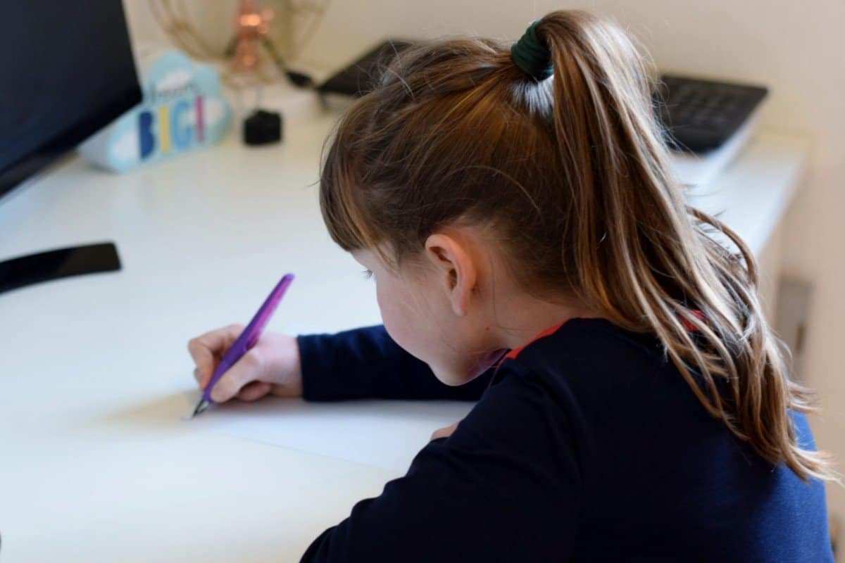 Little girl writing with Stabilo fountain pen