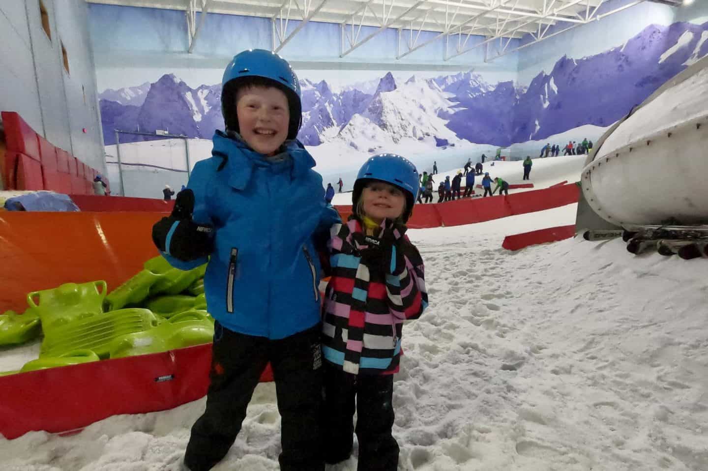 Brother and sister playing in the snow at Chill Factore - things to do in Manchester this summer