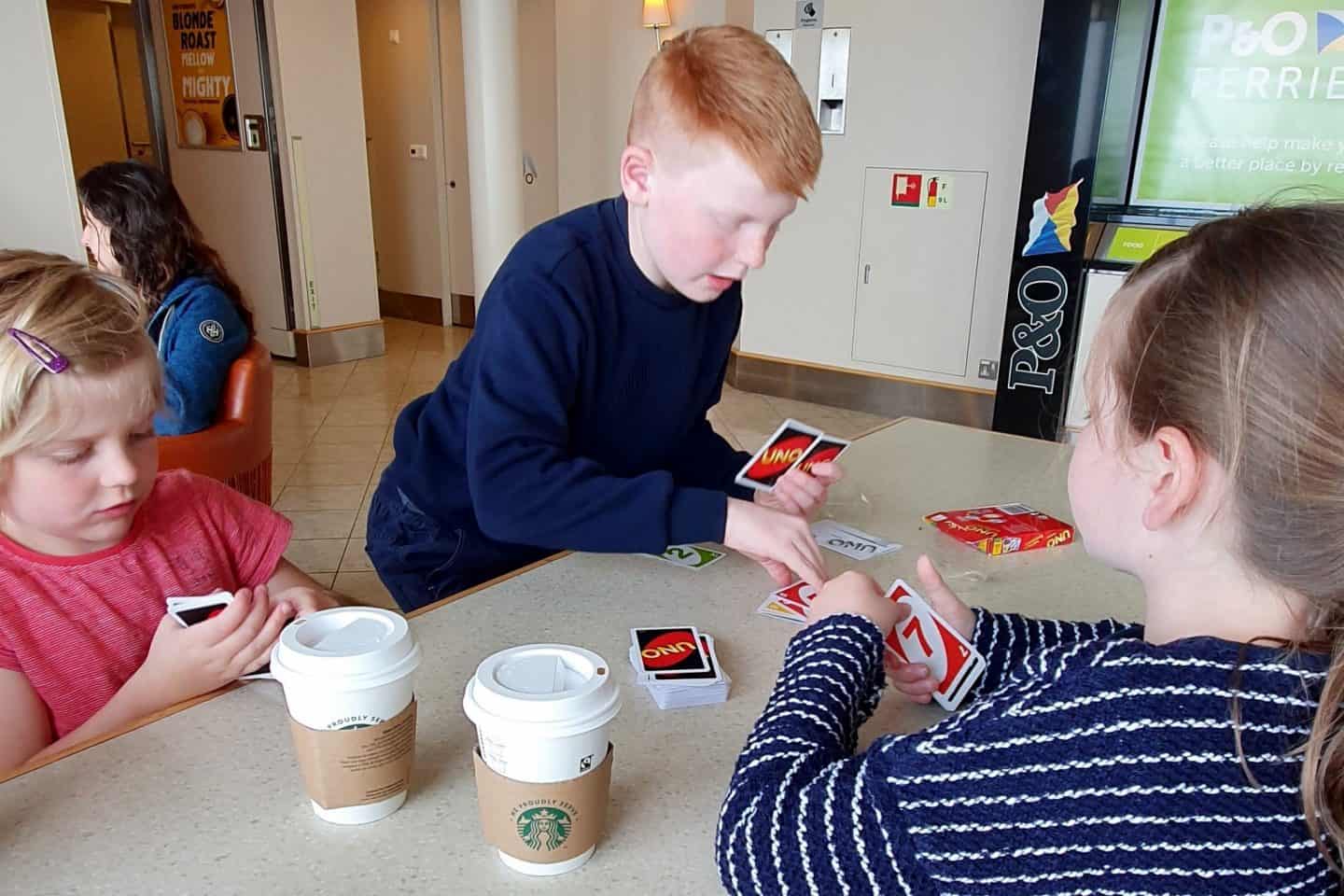 three children playing Uno on the ferry to France