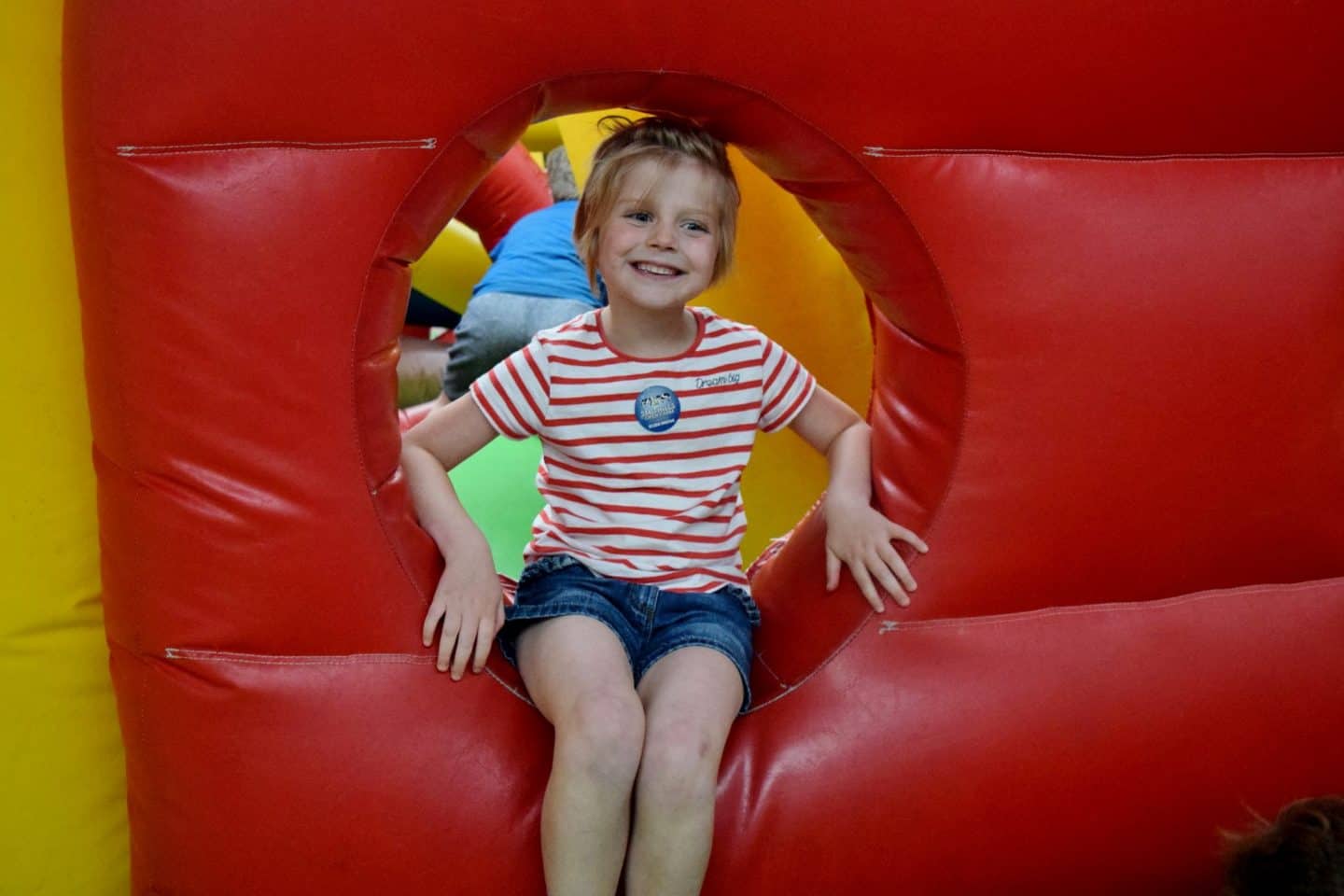 Little girl on indoor bouncy castle at Smithills Farm