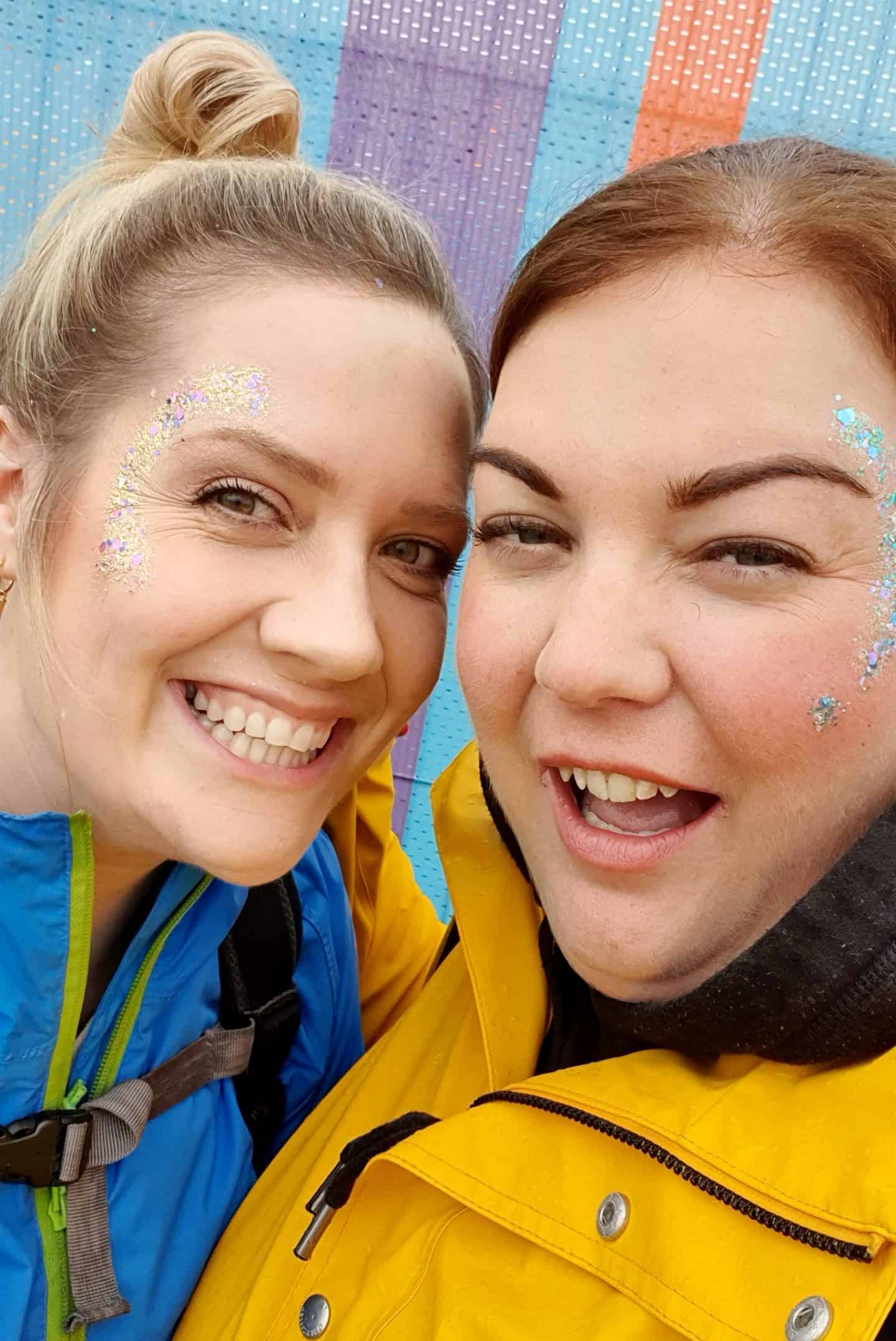 Best friends wearing festival glitter