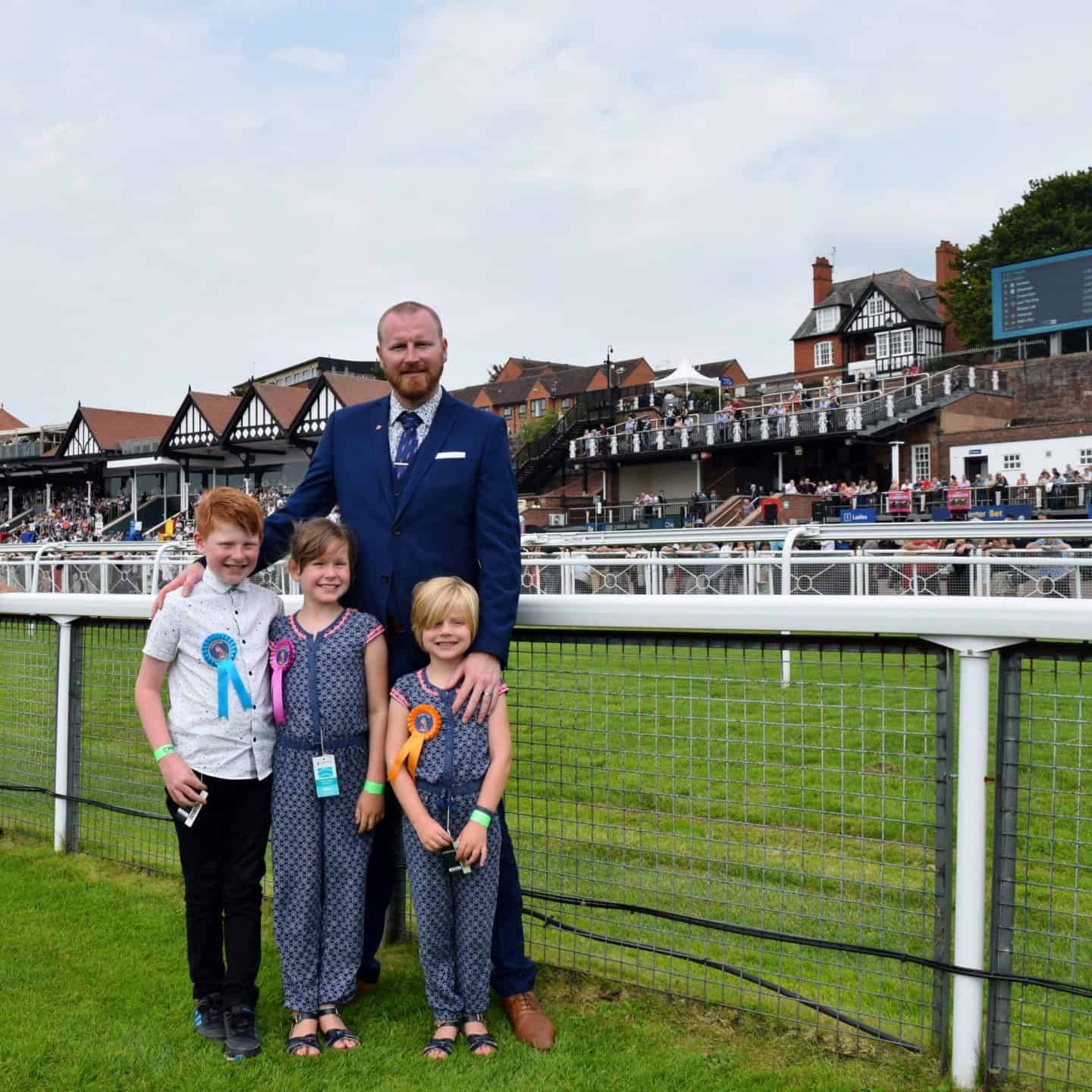 Dad and children dressed for a day at Chester races
