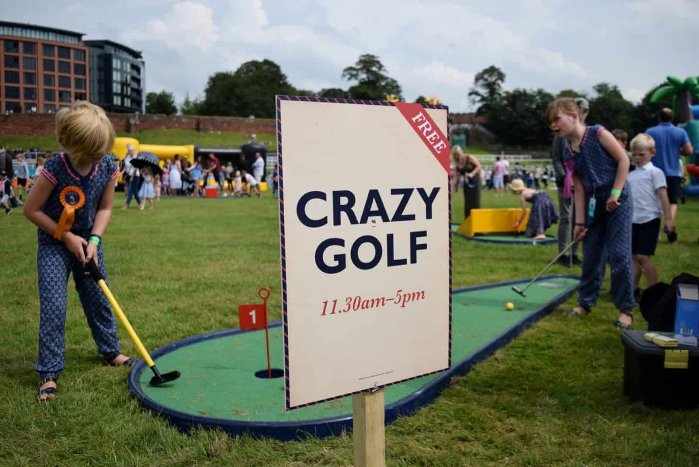 two girls playing Crazy Golf at Chester Racecourse