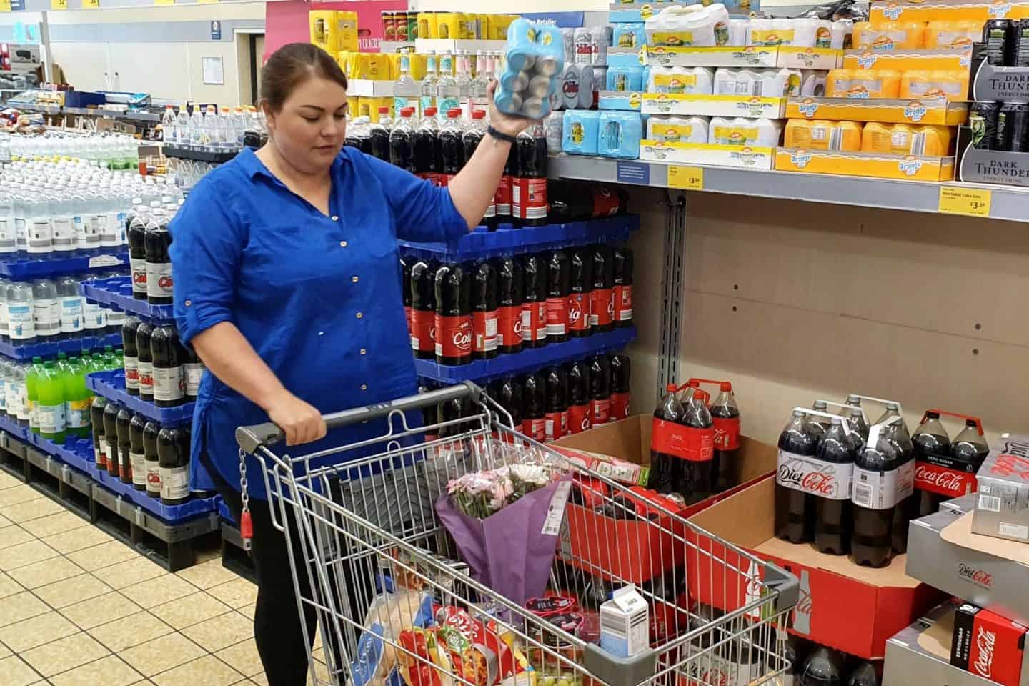 Mum shopping in Aldi - putting groceries in trolley