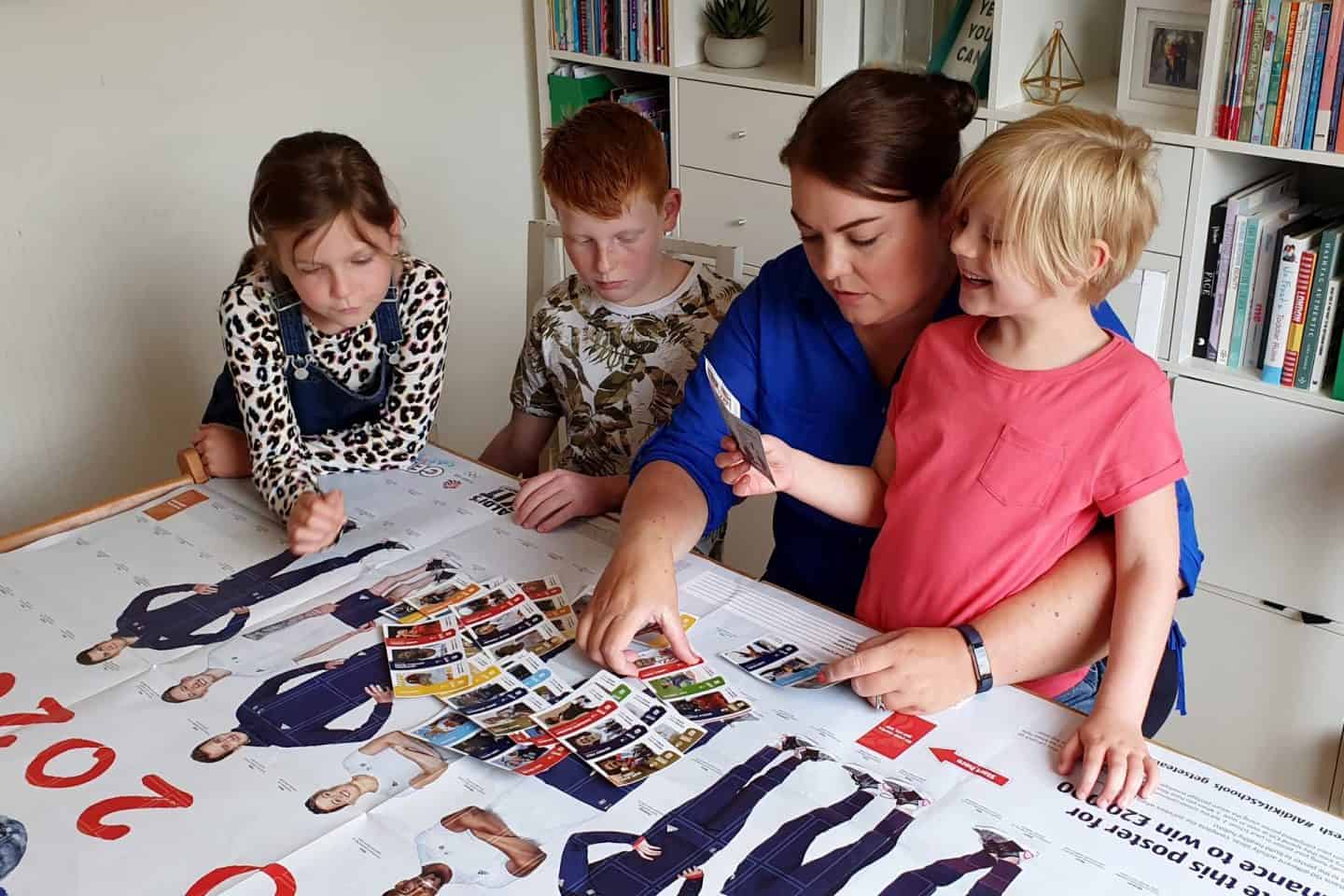 Mum and children looking at Aldi Kit for Schools stickers
