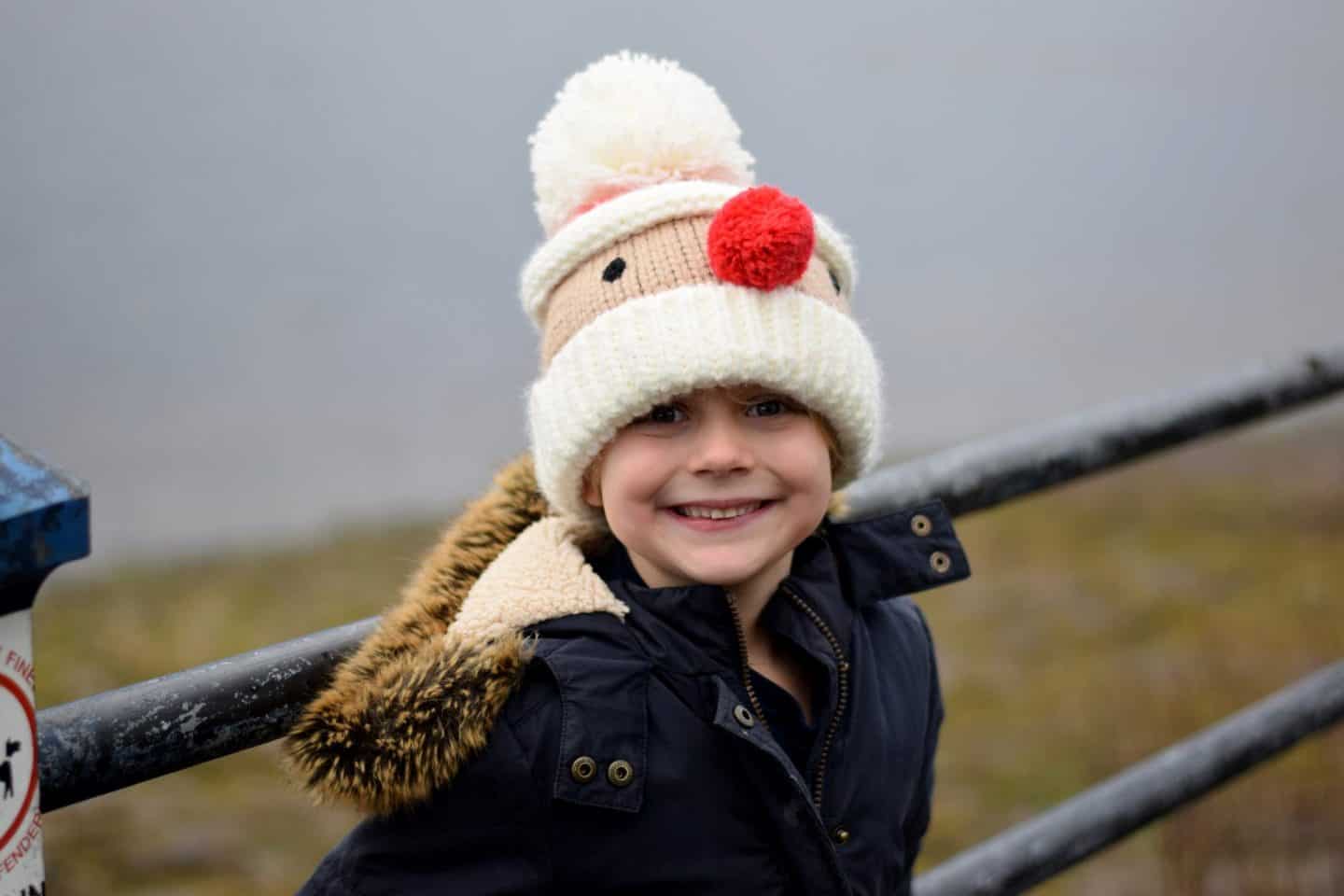 Little girl wearing Father Christmas woolly hat