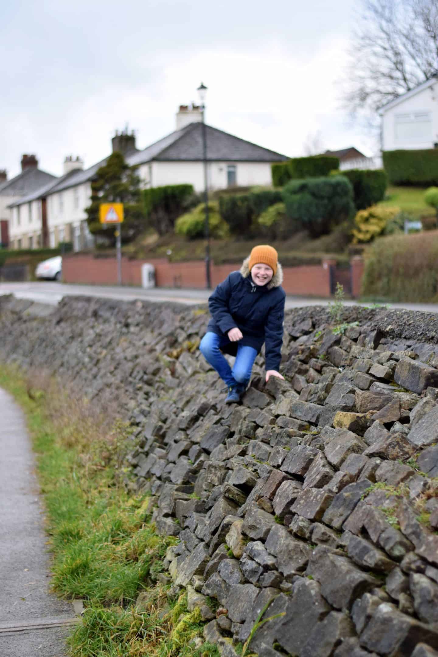 Boy climbing walls at Hollingworth Lake