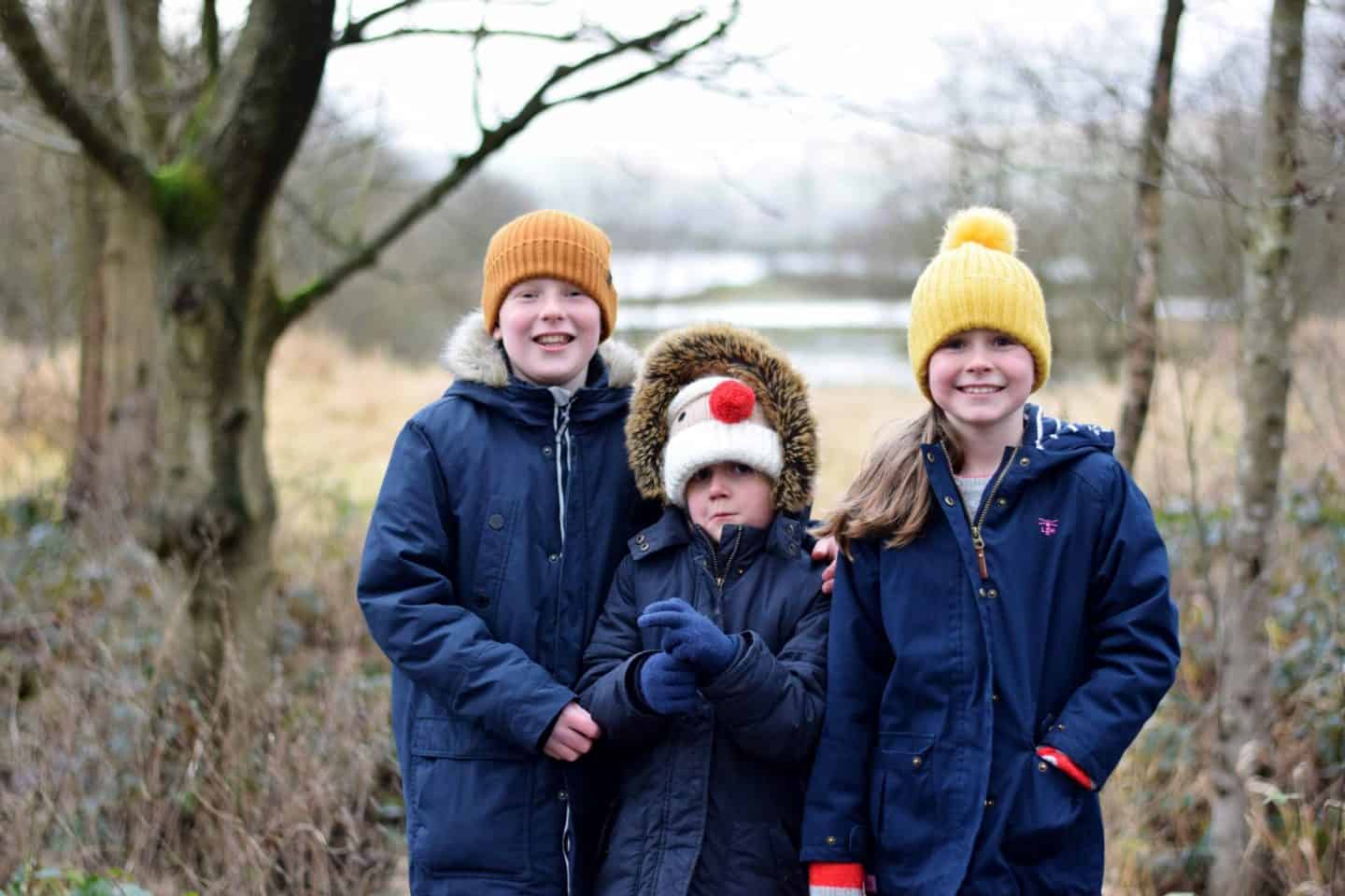 Siblings smiling on a cold winter's walk