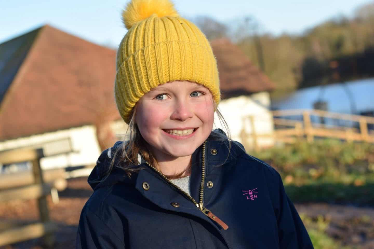 Smiley little girl in yellow hat