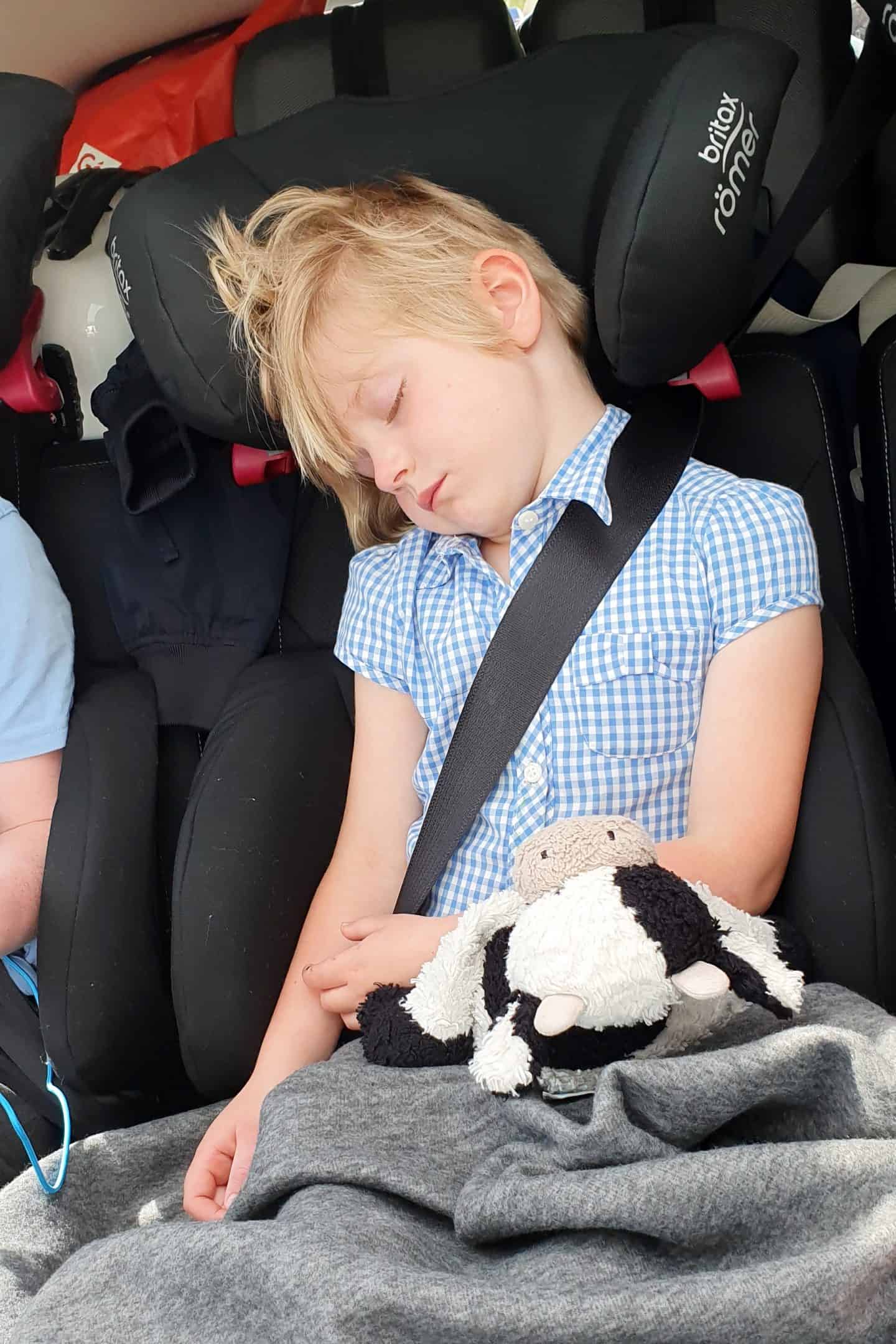 Little girl sleeping in the car on a long journey