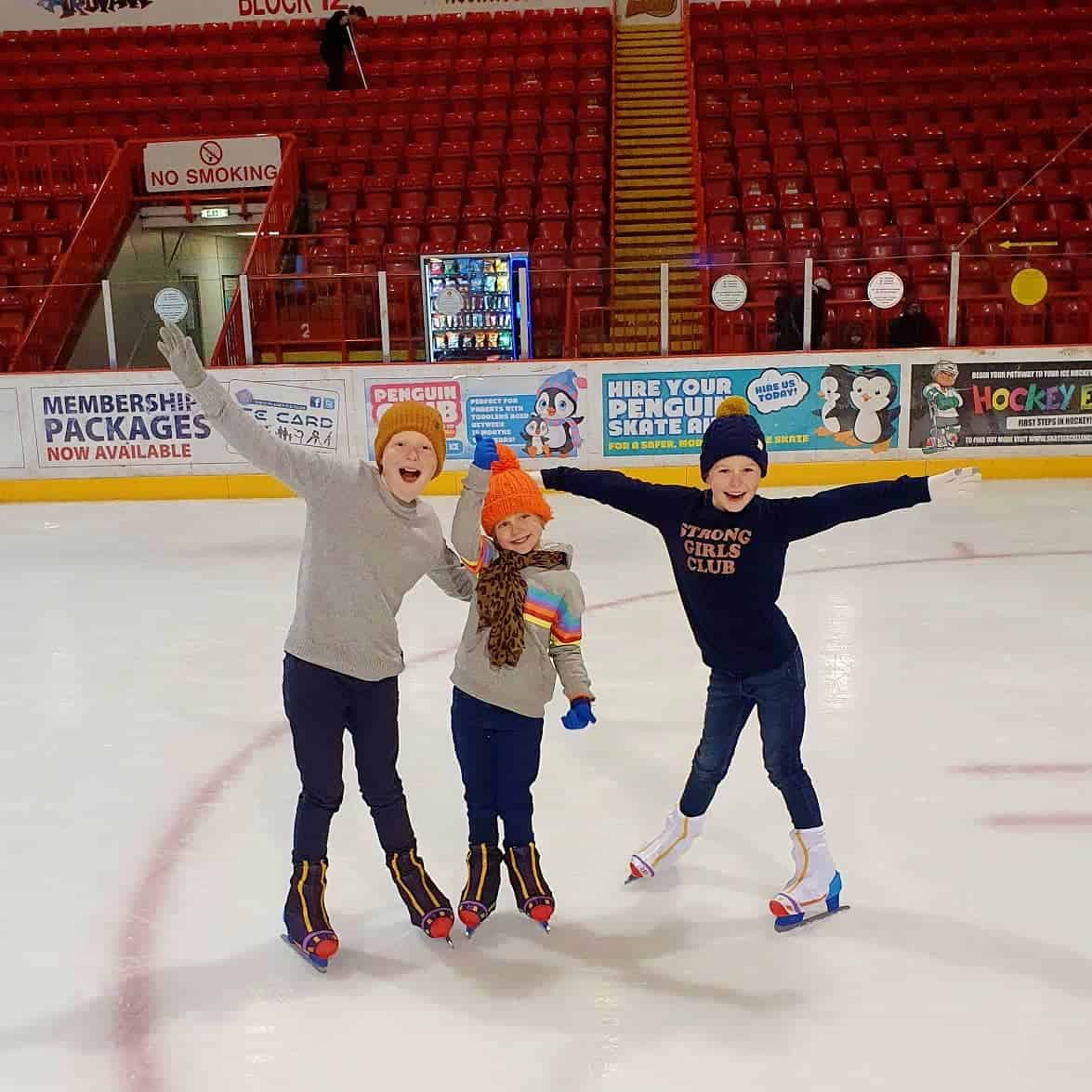 Three kids on the ice rink in Blackburn