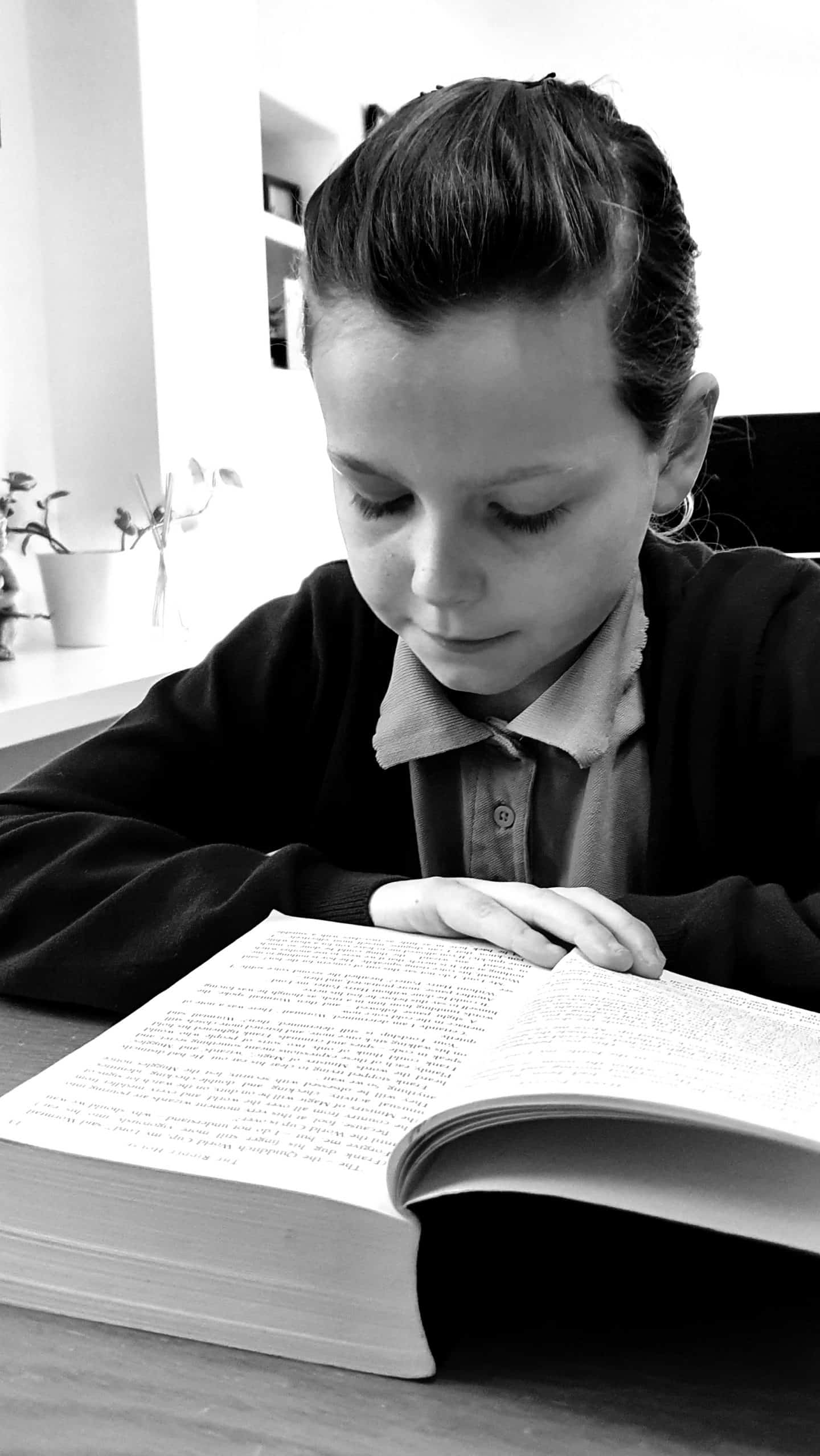 Girl reading an enormous book