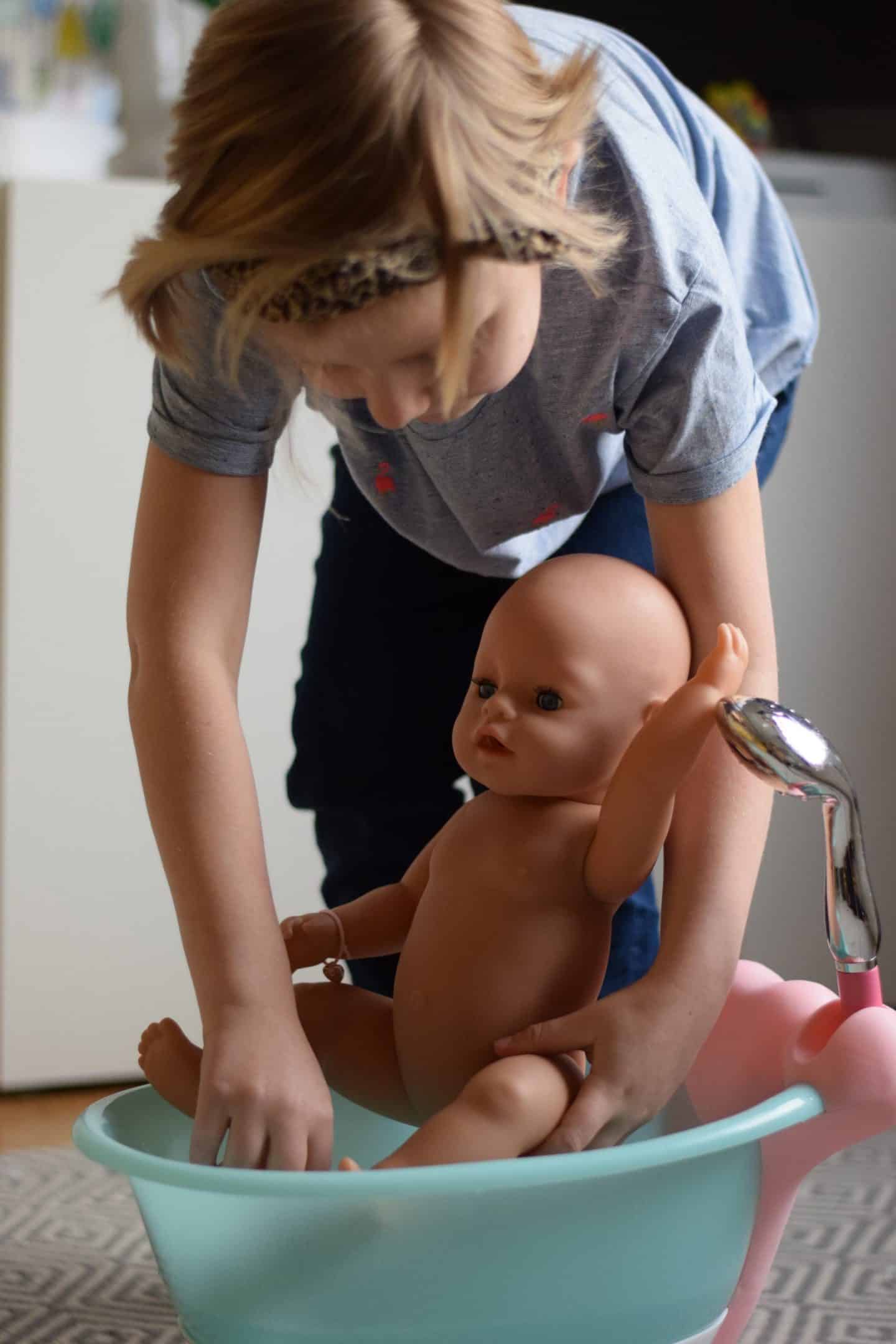 Amy bathing her doll