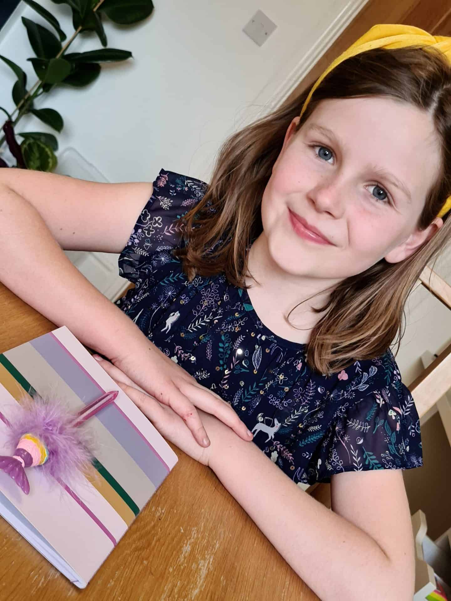 Girl ready to write in her new notebook
