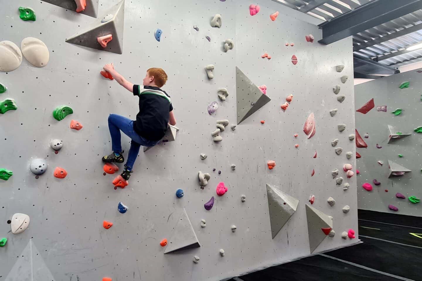 Having a go at an orange climbing route