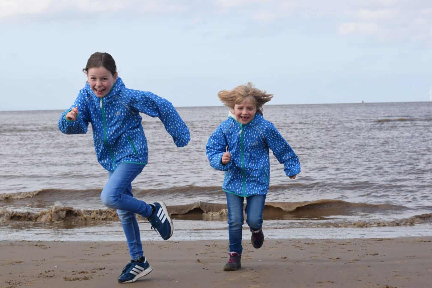girls running on Crosby beach