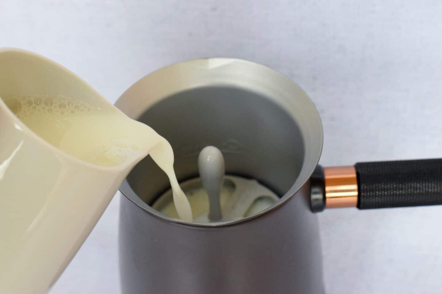Pour your choice of milk up to the marked line (Hotel Chocolat recommend semi skimmed milk but you can use any milk you like - including plant based or even just water)
