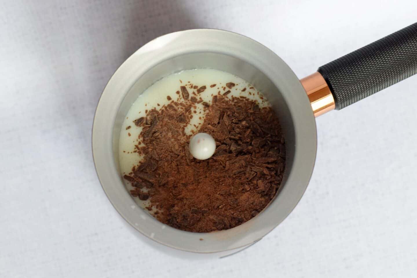chocolate flakes and milk in the hot chocolate maker