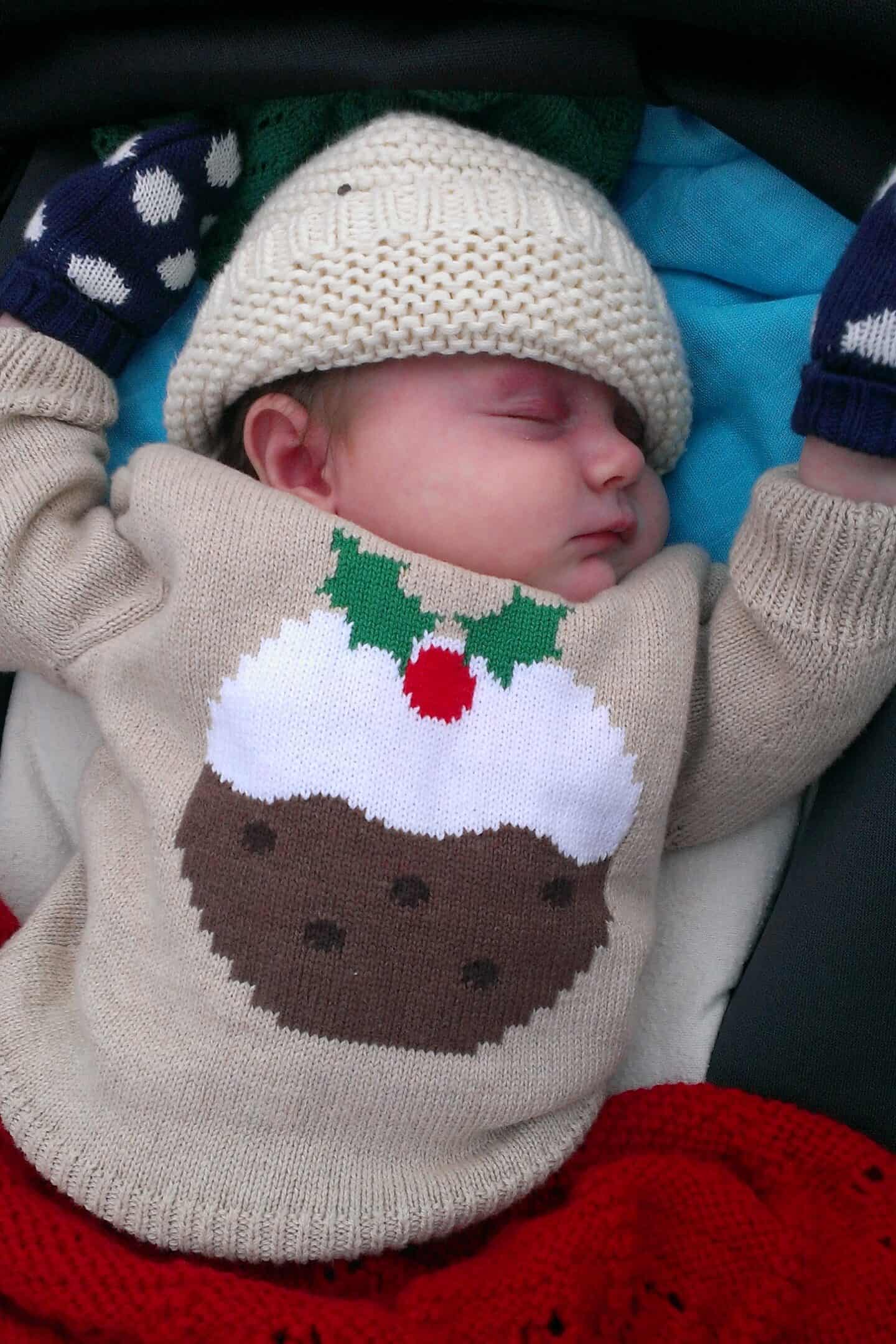 Newborn baby wearing a Christmas pudding jumper
