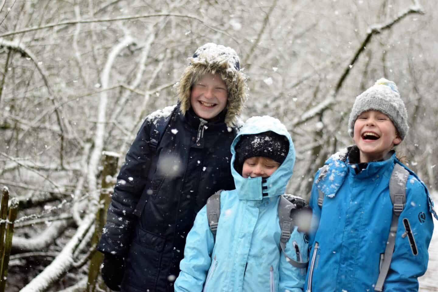 Siblings laughing in the snow
