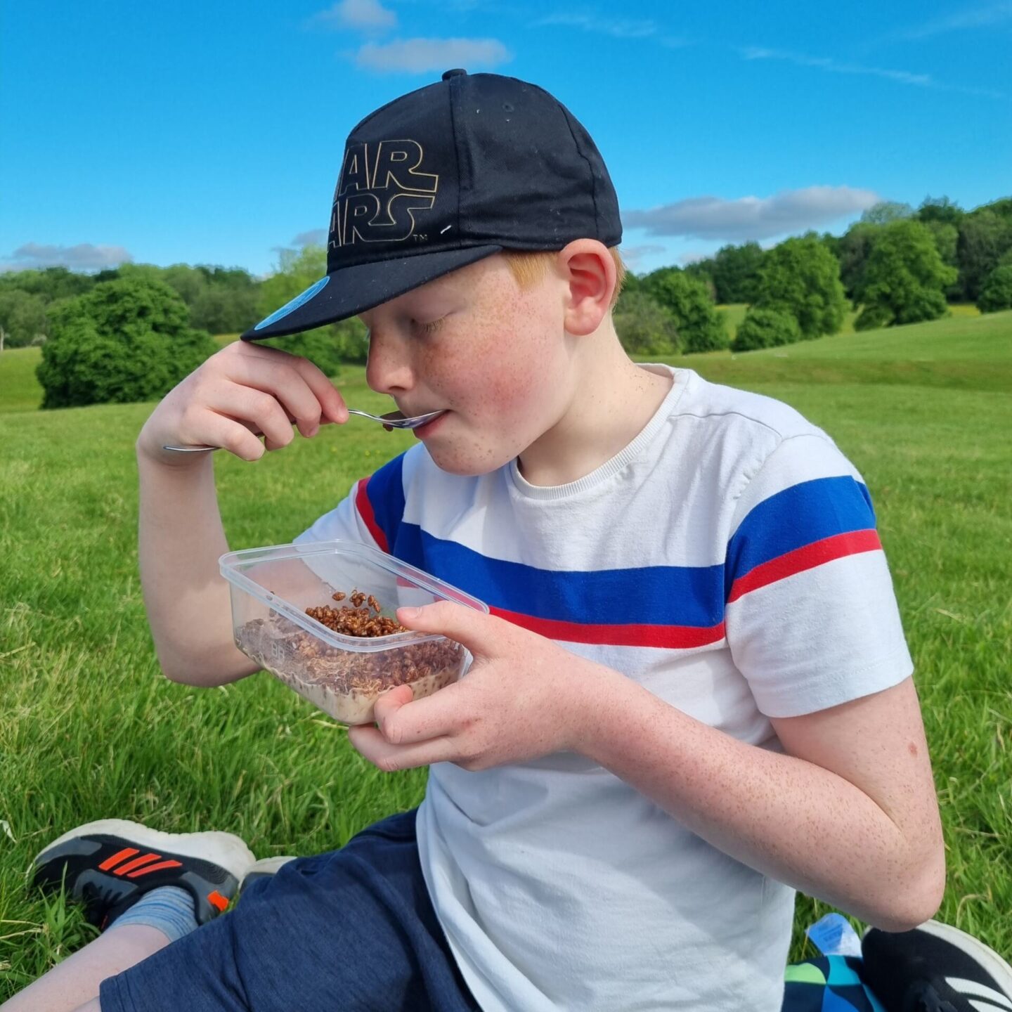 eating cereal from tupperware on a breakfast picnic