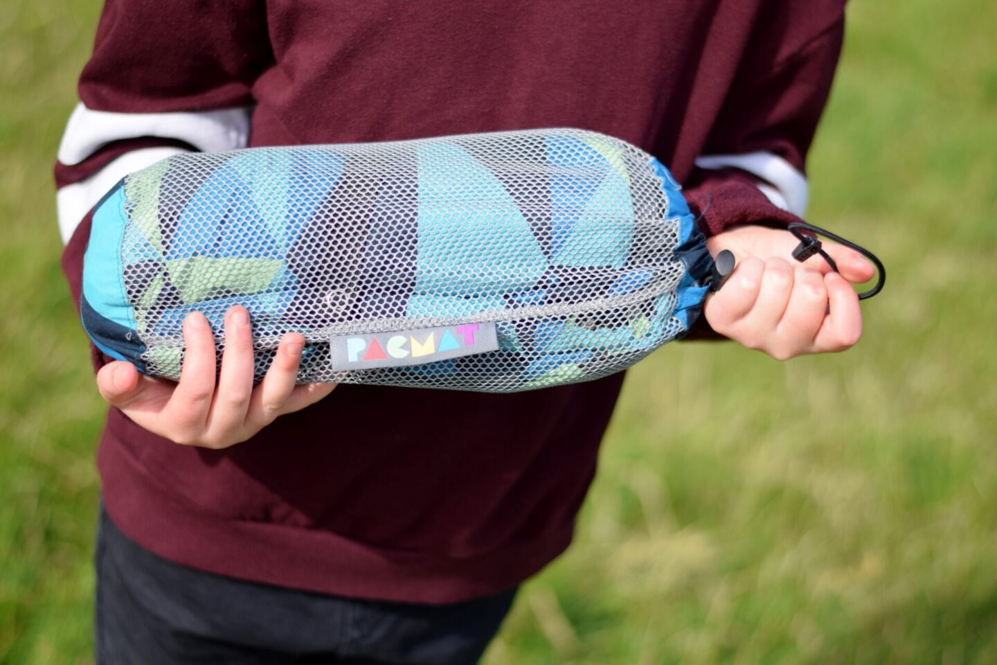 The XL picnic blanket folds down into a mesh bag to make it easy to carry