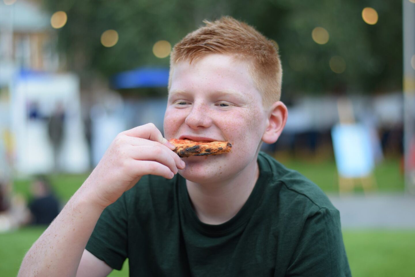 Ben eating freshly made woodfire pizza at Festa Italiana, Manchester