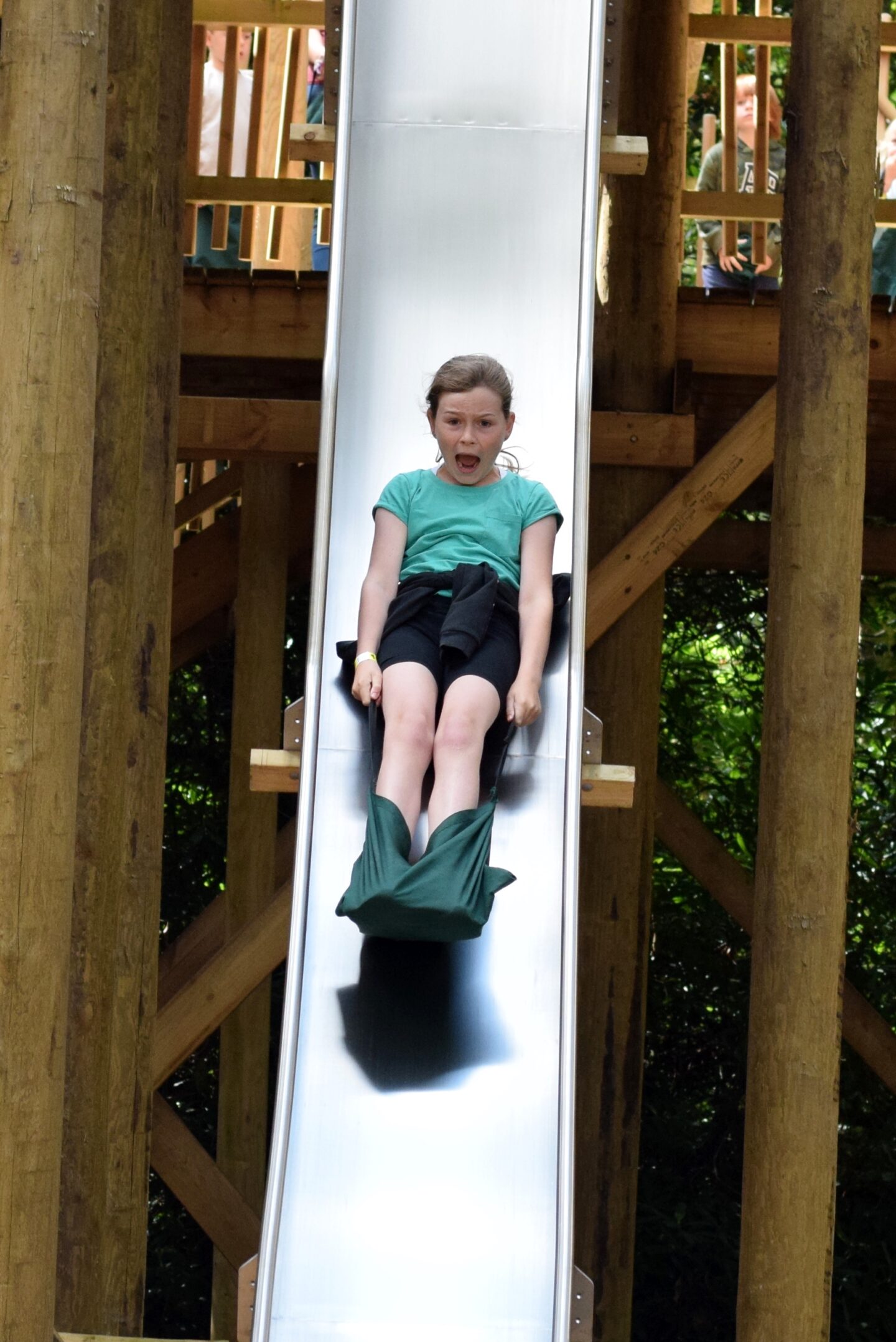 Little girl showing pure fear on her face on the biggest slide!