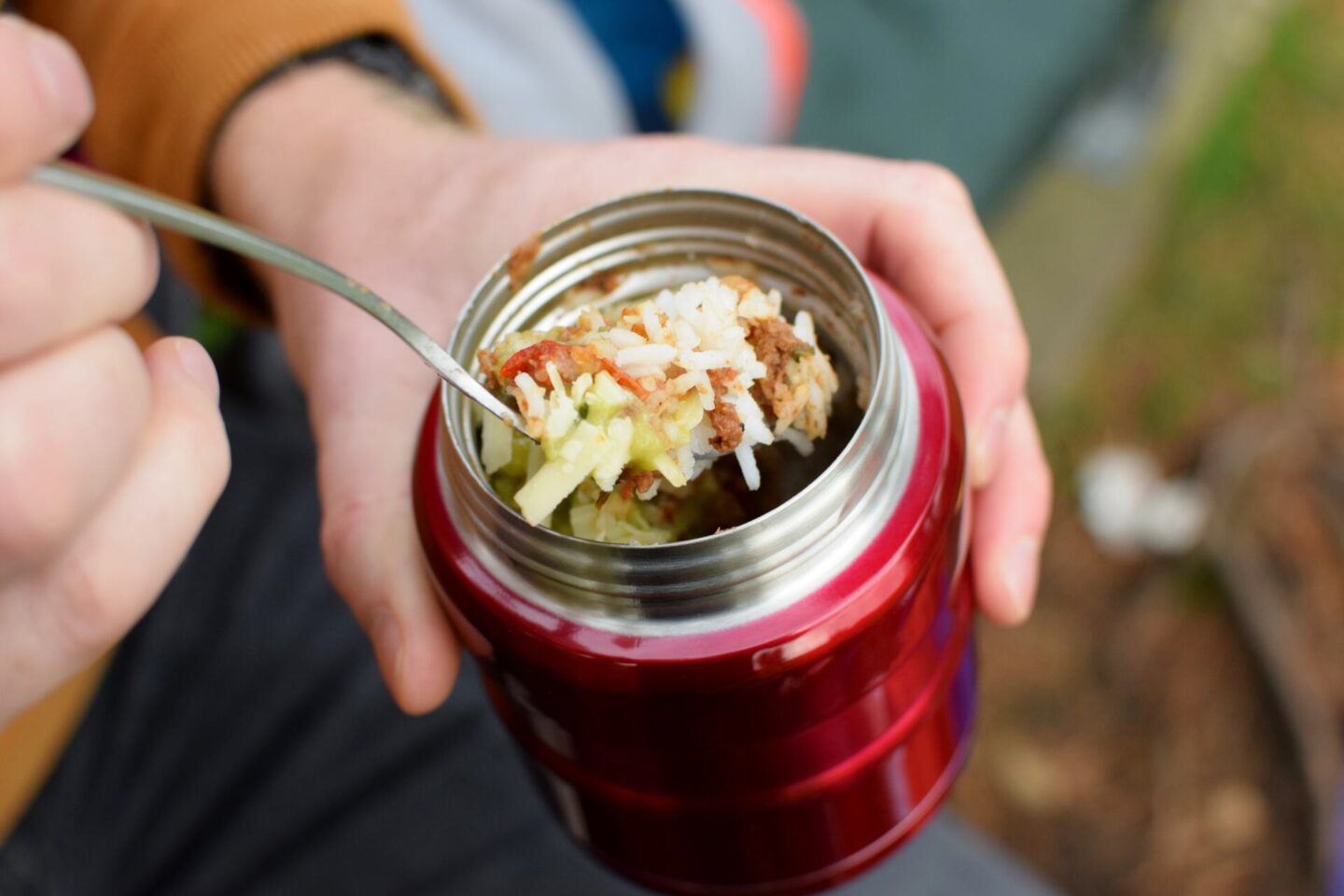 A close up of the Thermos King food flask packed with chilli and rice for a warming hot picnic