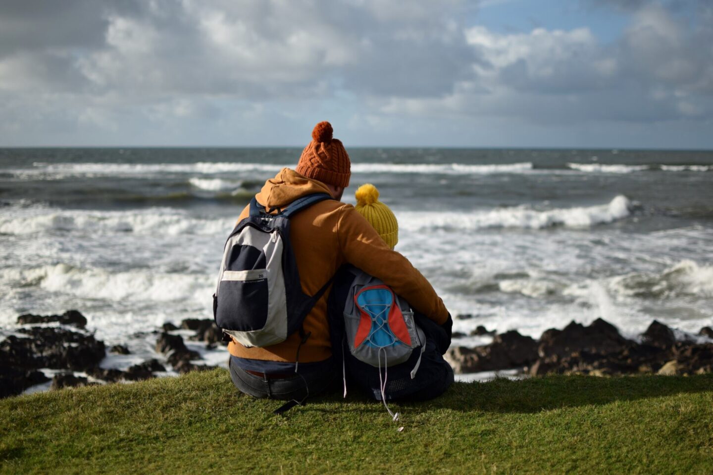 Father and daughter looking out to see at Rhossili
