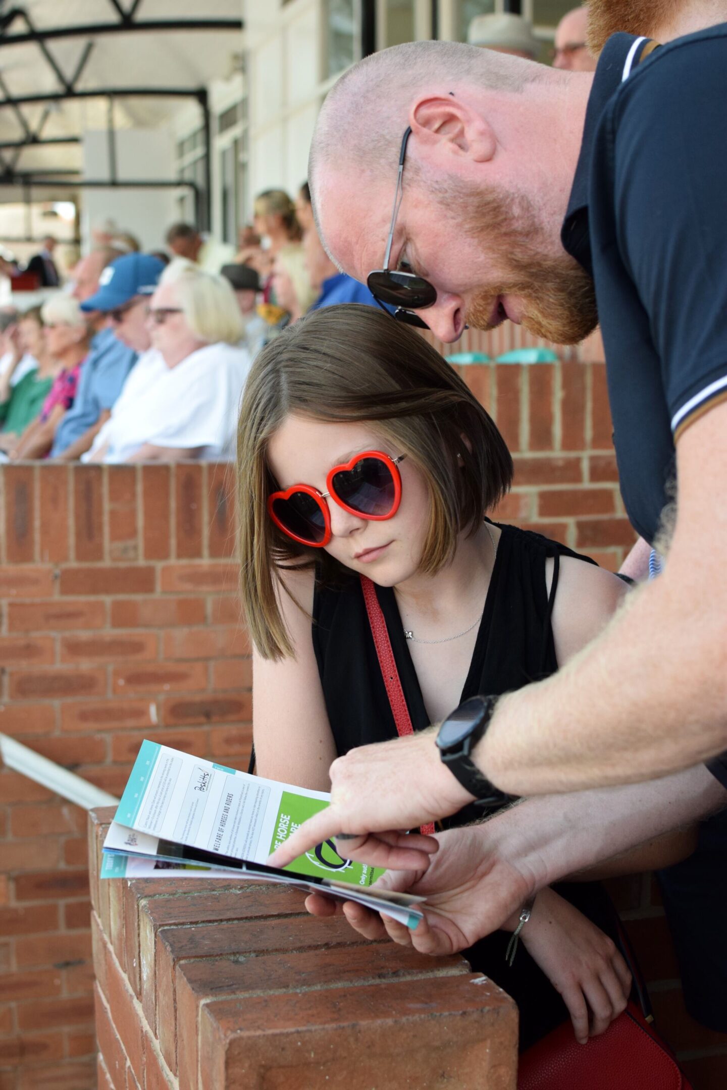 Checking the race card and choosing horses