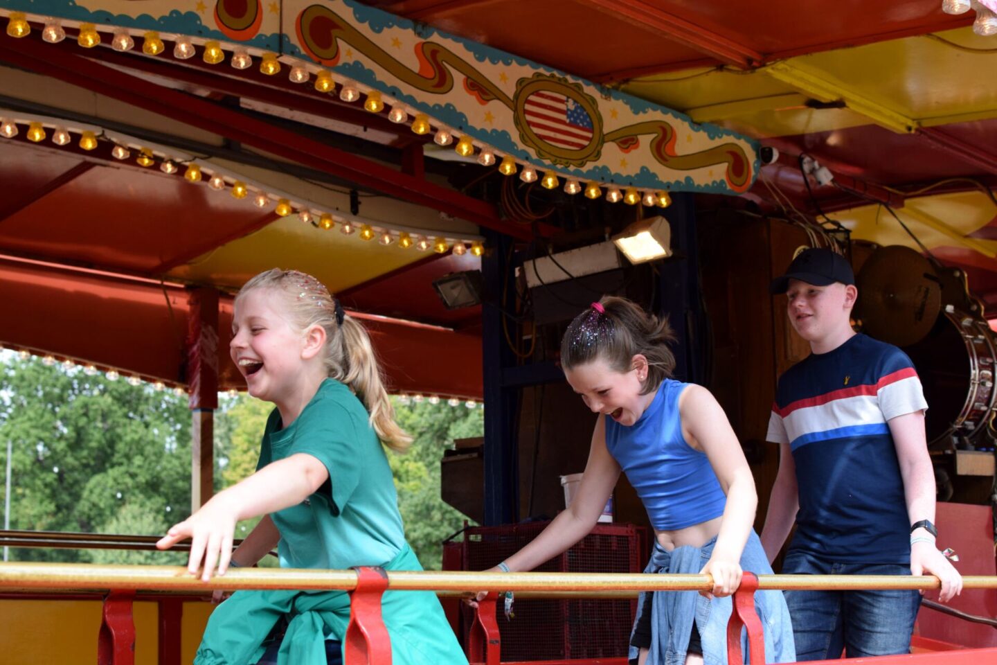Kids on fairground rides at a festival