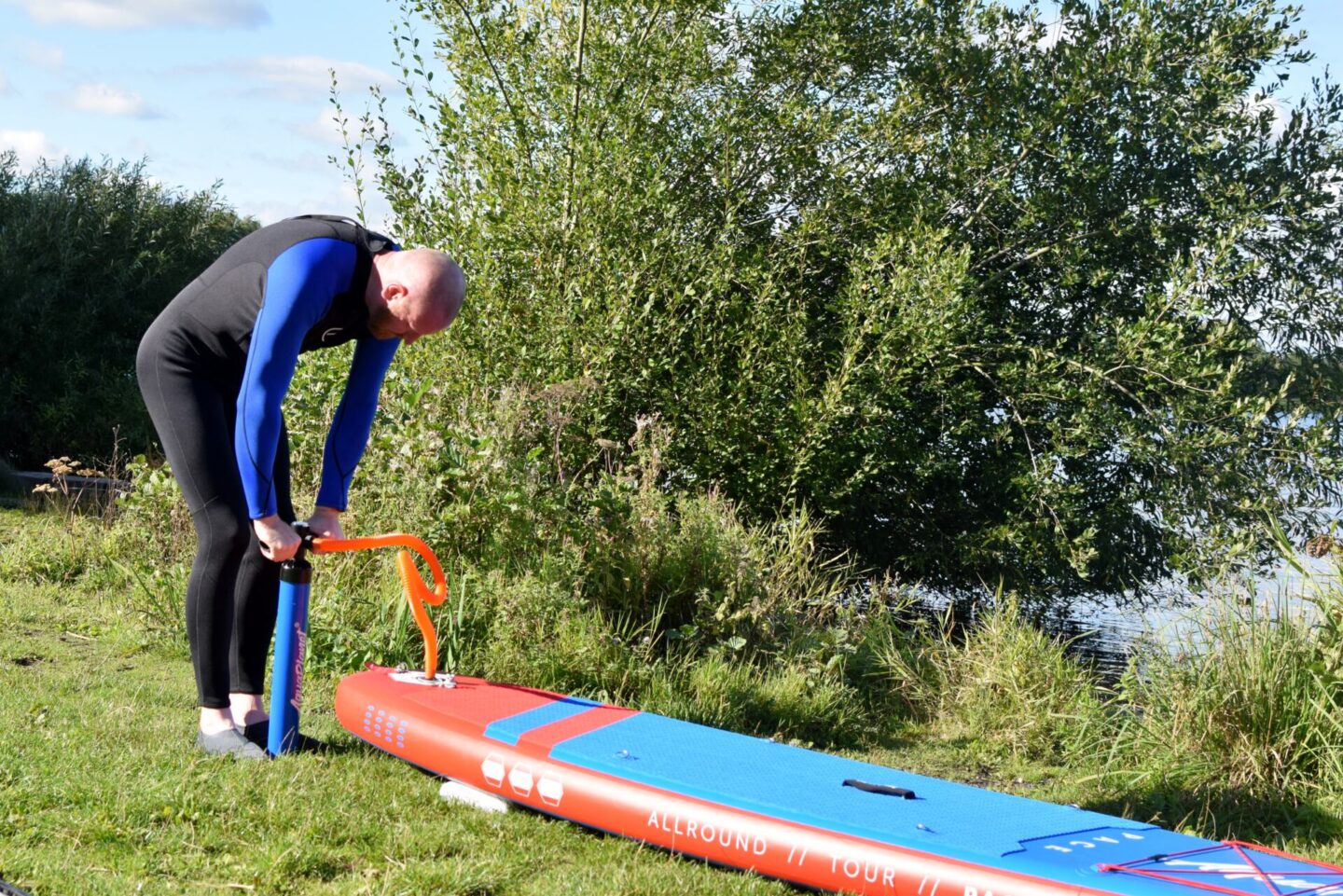 Inflating our Aquaplanet PACE Paddleboard / SUP at the water's edge.