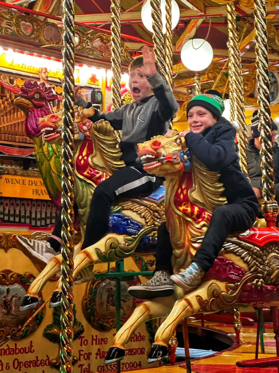 Brothers enjoying the traditional fairground rides at Kew Gardens this Christmas