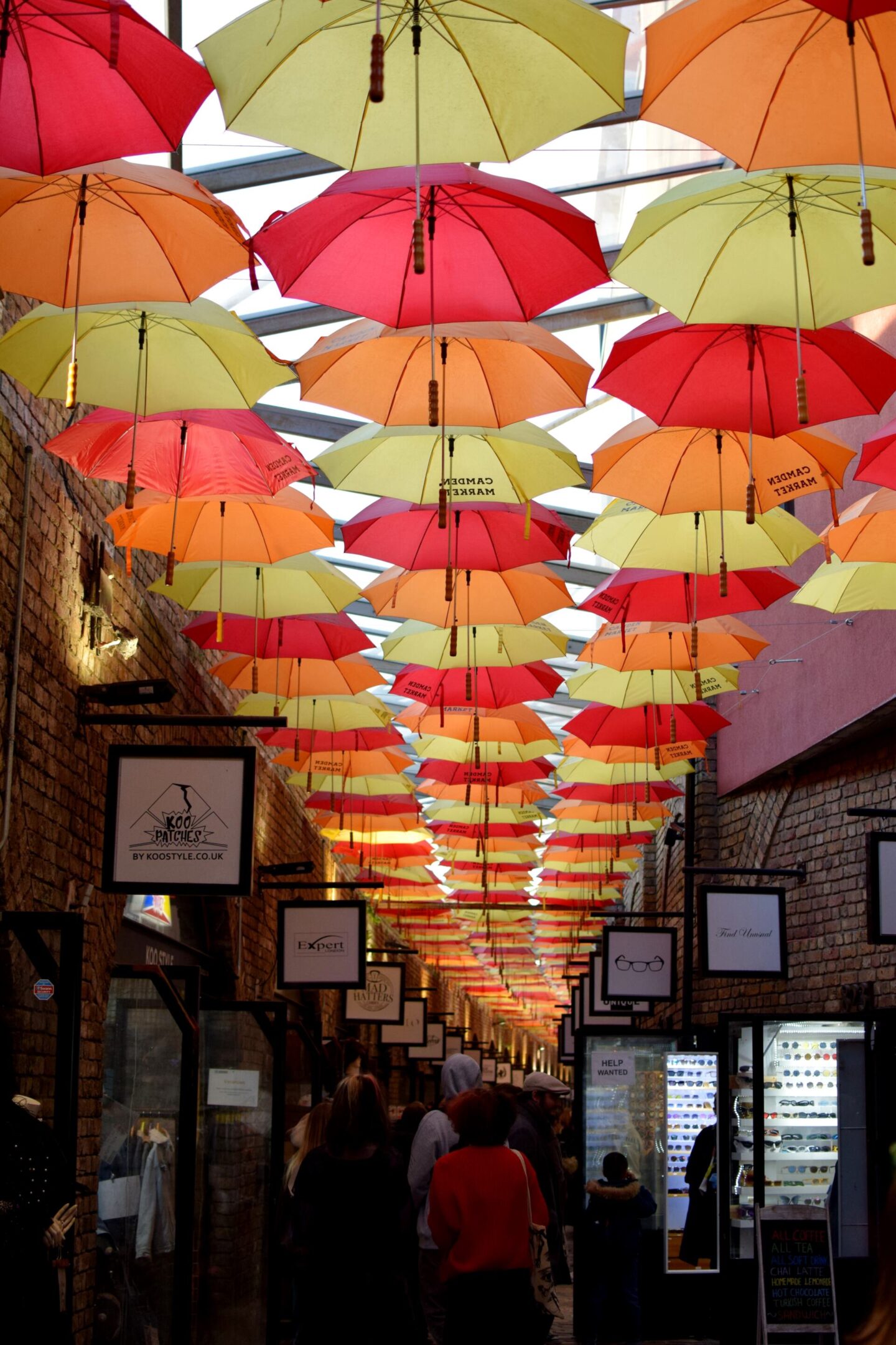 Brightly coloured umbrellas hanging from the ceiling at Camden Market