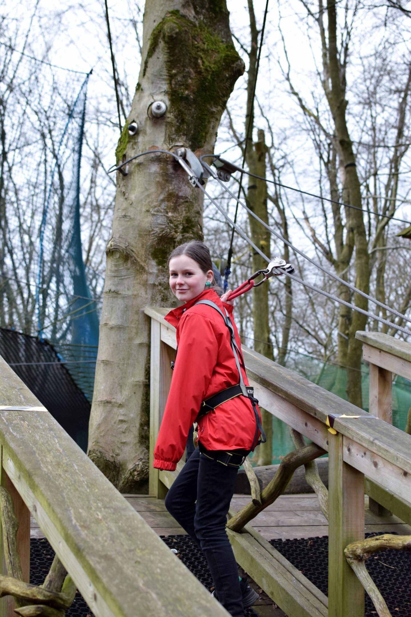 Chloe smiles at the camera as she sets off on her TreeTop Trek adventure!