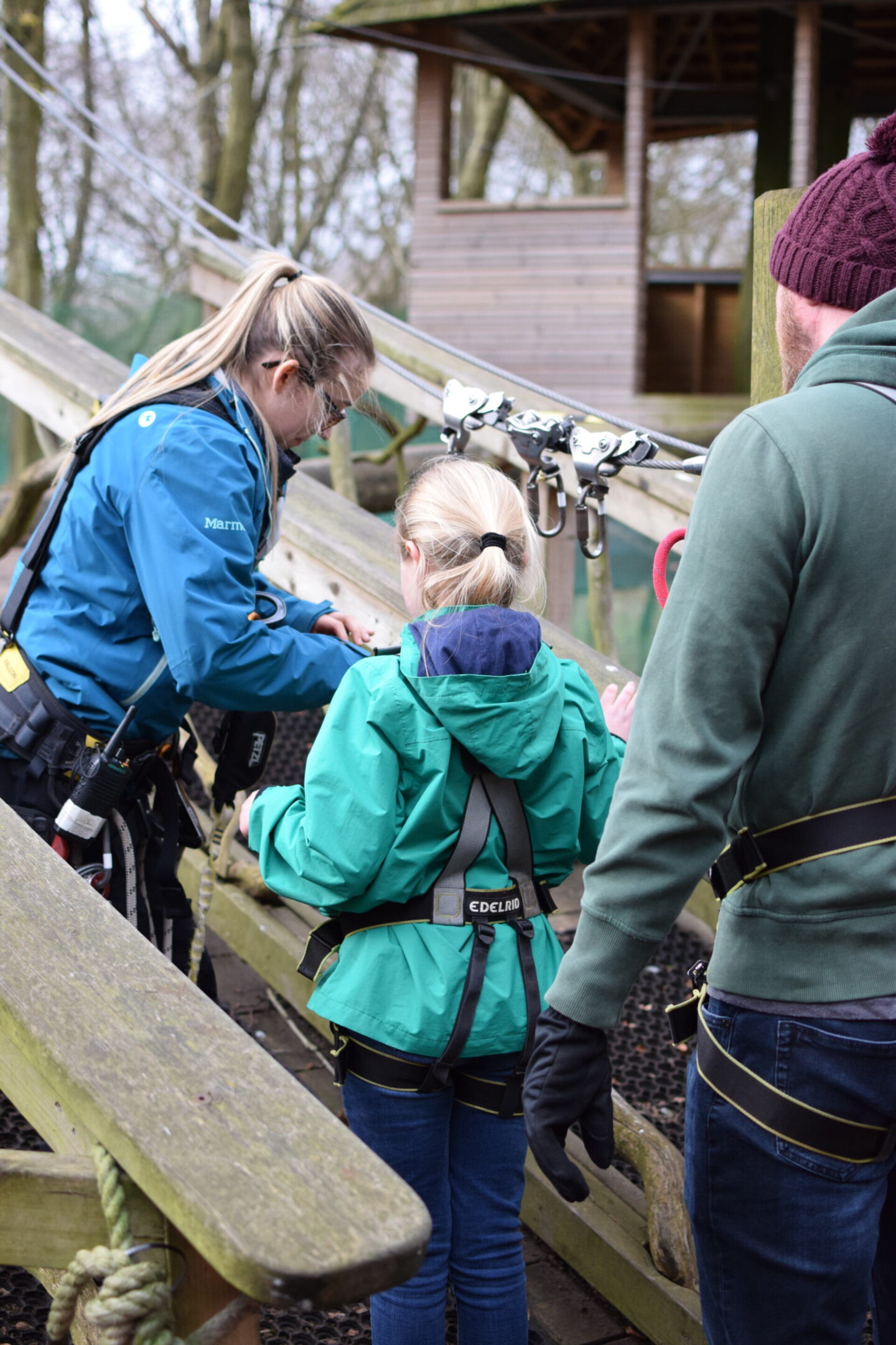 Demi fastens Amy safely to her pulley - TreeTop Trek is a continuous pulley system so this doesn't come off again till the end of the trek