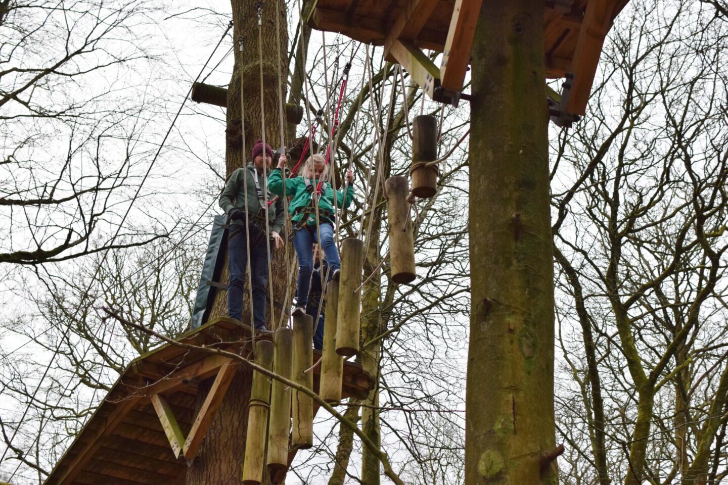 Amy bravely tackles TreeTop Trek whilst Dad watches on behind