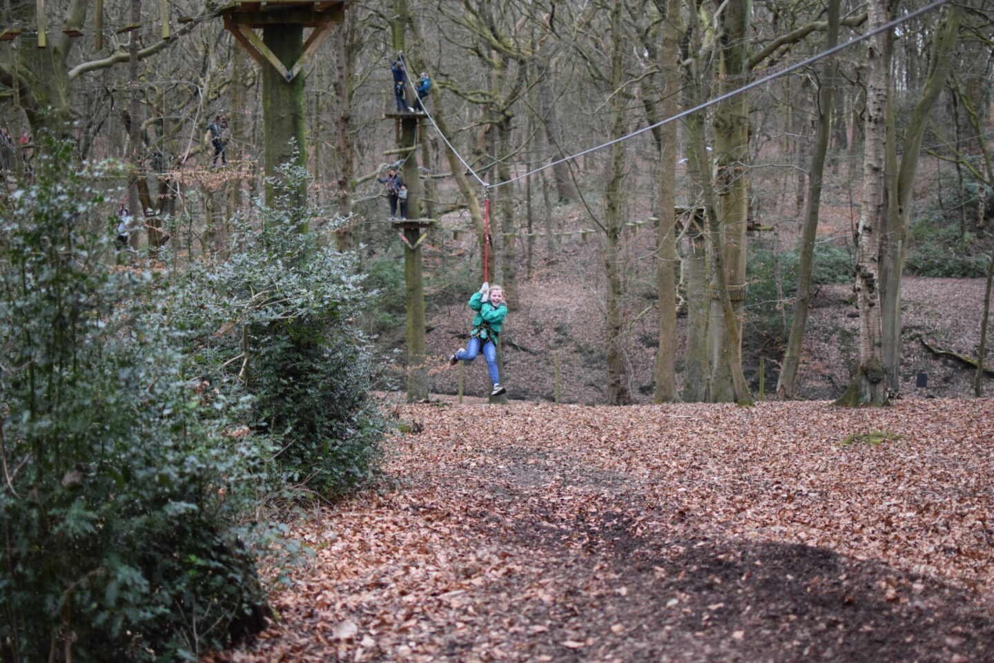 Amy smiling as she whizzes through the air on the last of the TreeTop Trek zipwires.