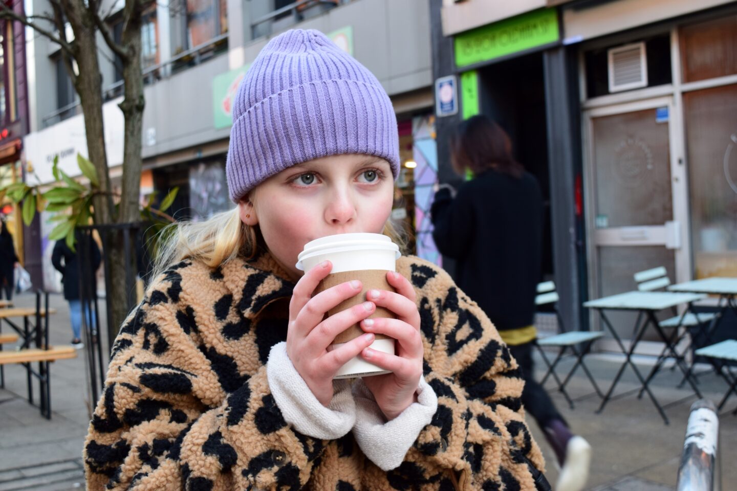 Amy with her cold hands wrapped around a take away tea from Fig + Sparrow