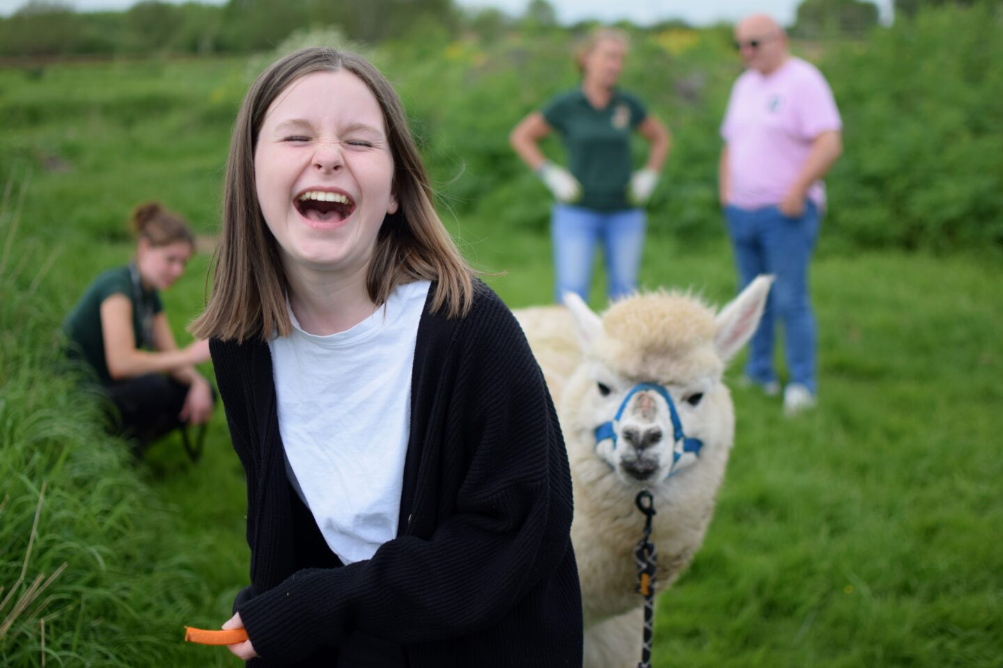 Chloe laughing when her alpaca tried to steal carrots from her