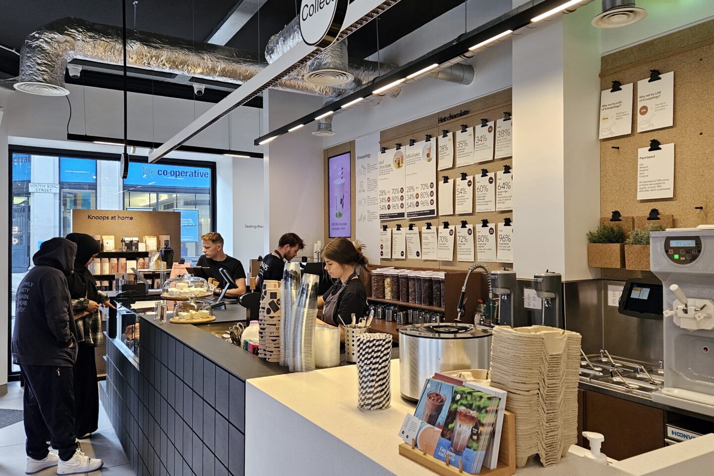 Inside Knoops Manchester - staff are busy making some of the best hot chocolate in Manchester from an extensive menu.