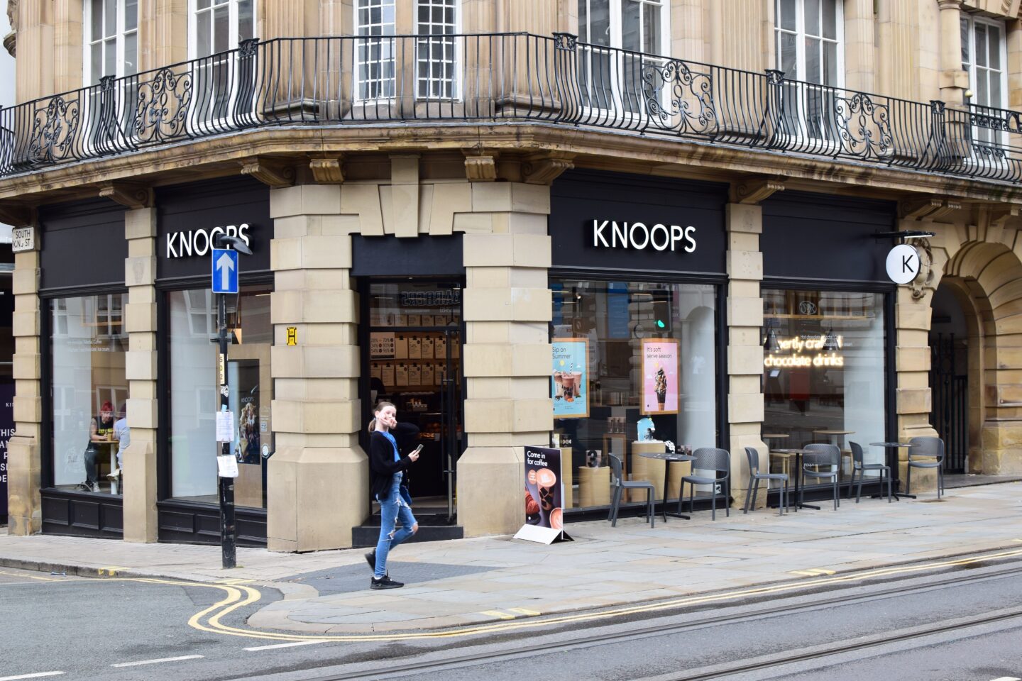 Knoops Manchester city centre with Chloe standing outside the door pulling a standard teenage peace sign pose