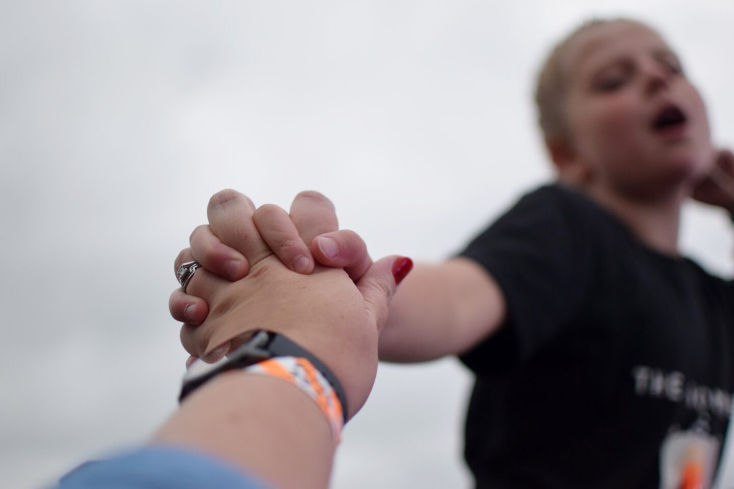 Blurred in the background, Amy singing her heart out to the Wombats holding her Mum's hand which is in focus!