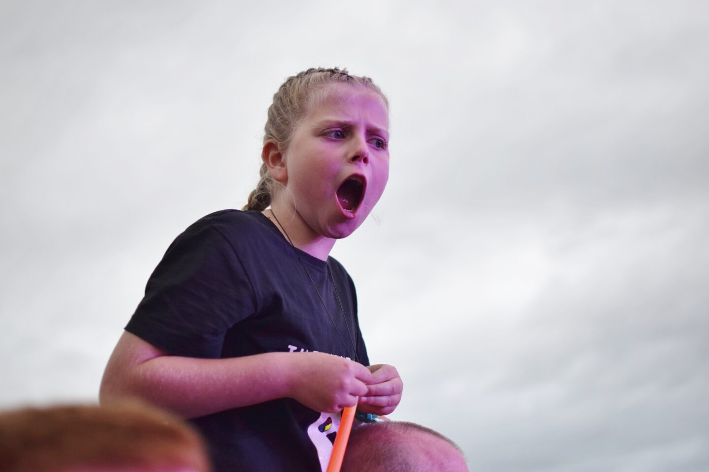 Amy sat on her Dad's shoulders singing enthusiastically to the Wombats at Y Not Festival 2023
