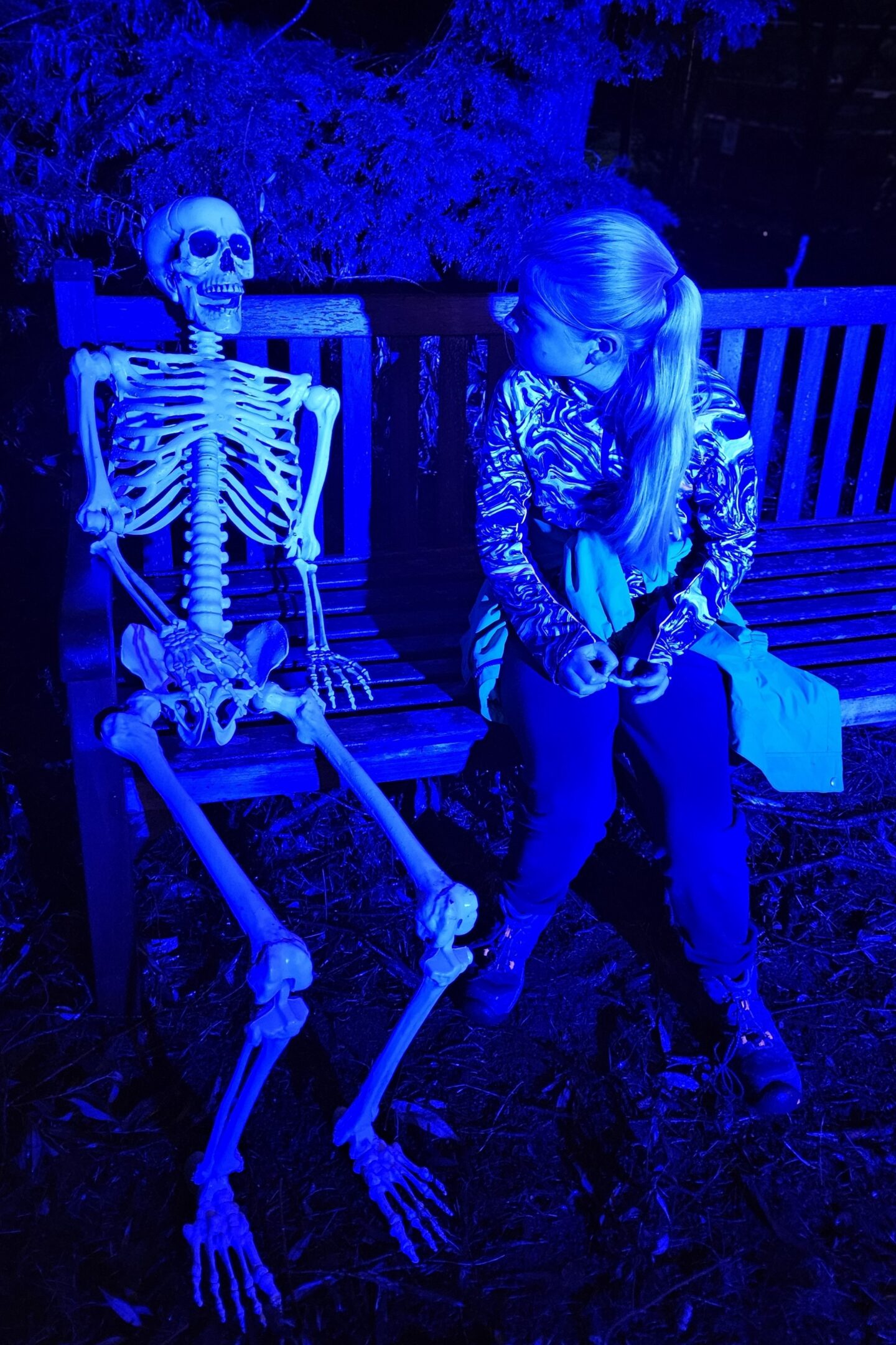 Amy having a good old chat with a skeleton at the Halloween Lakeside Trail