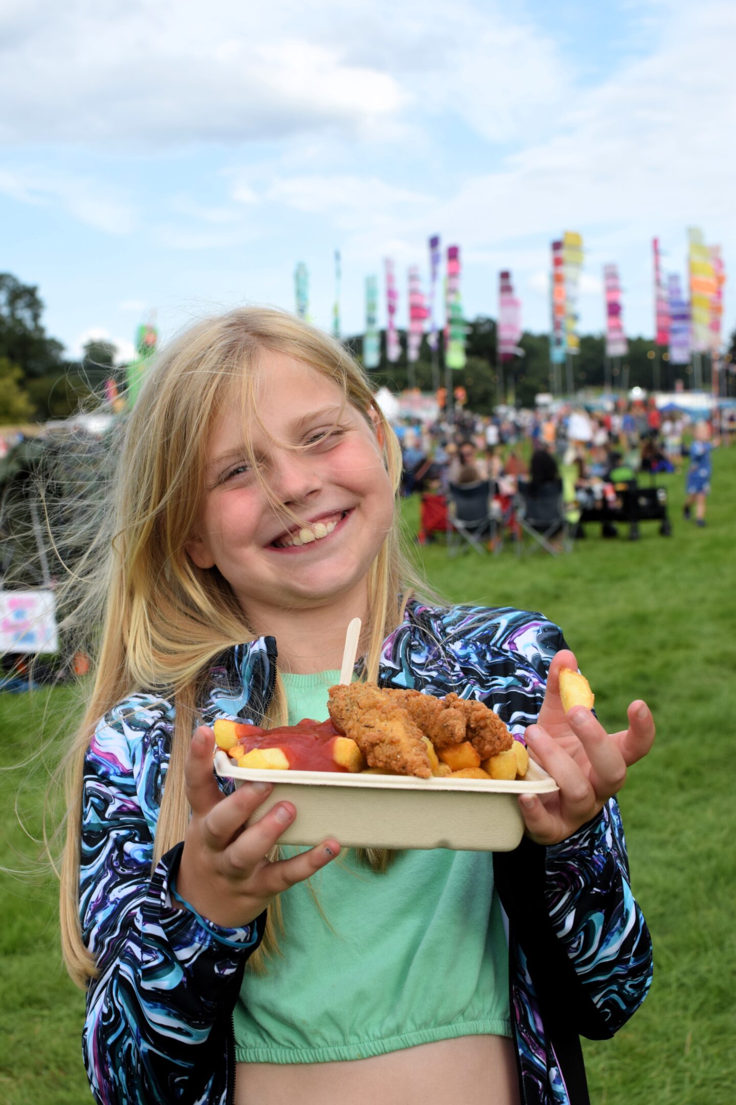 Amy with a portion of chunky chicken and chips at Camp Bestival Shropshire 2023