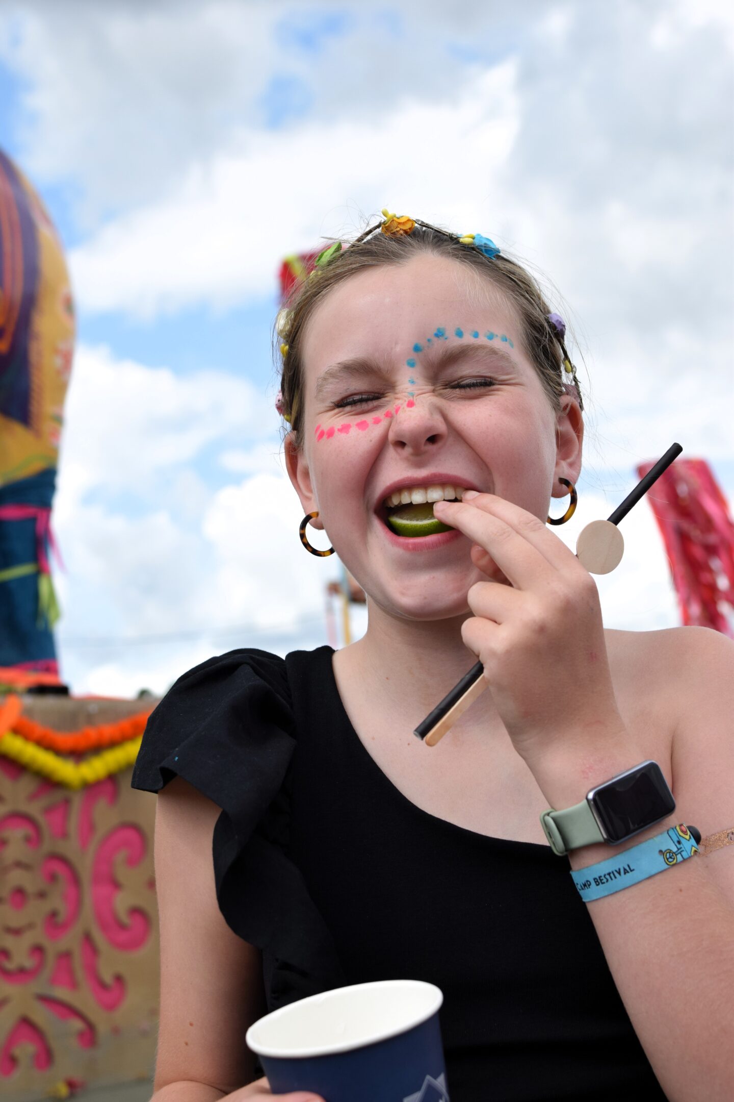 Chloe eating the lime from her drink and pulling a face