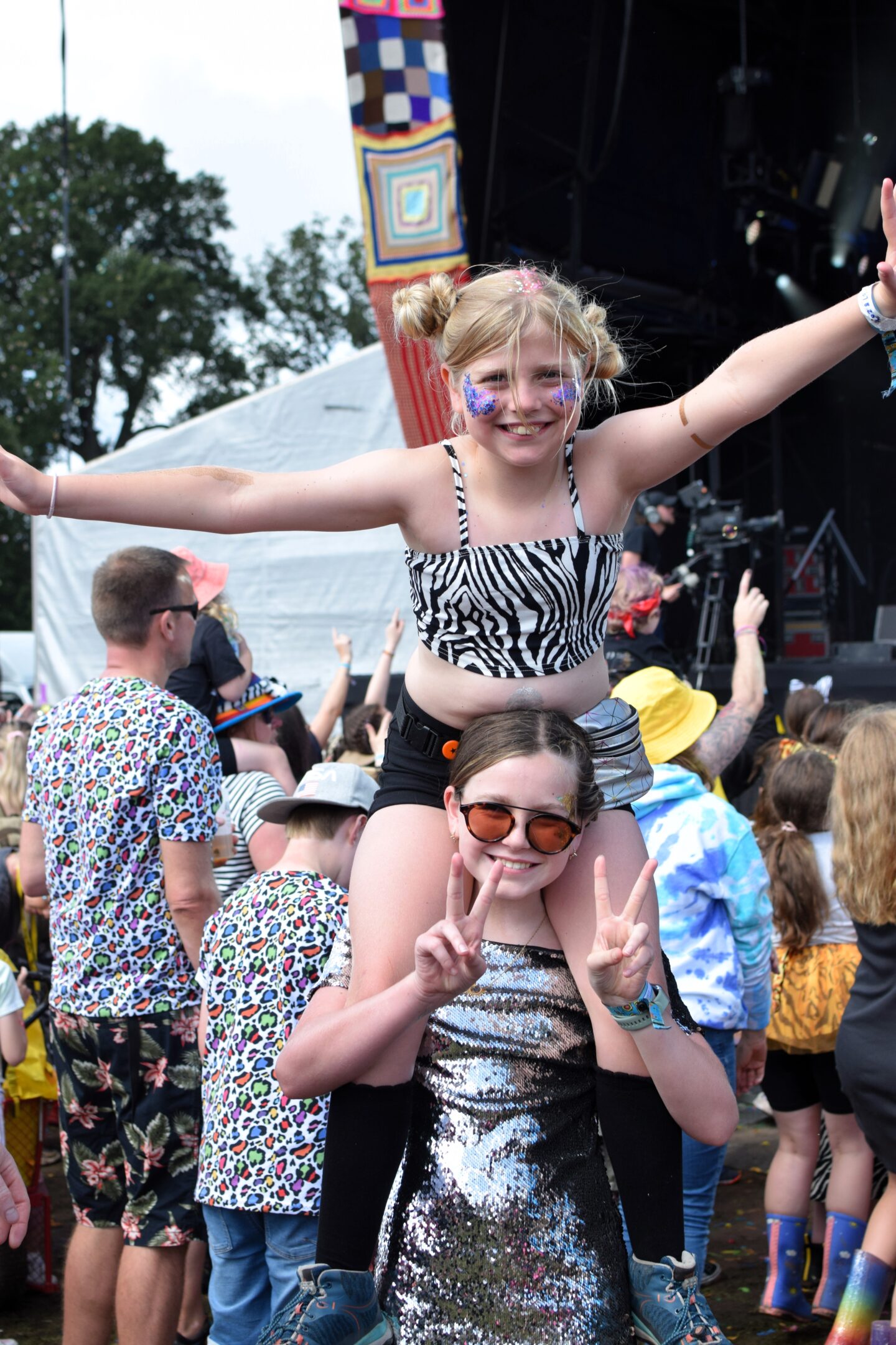 Amy on Chloe's shoulders watching Dick & Dom