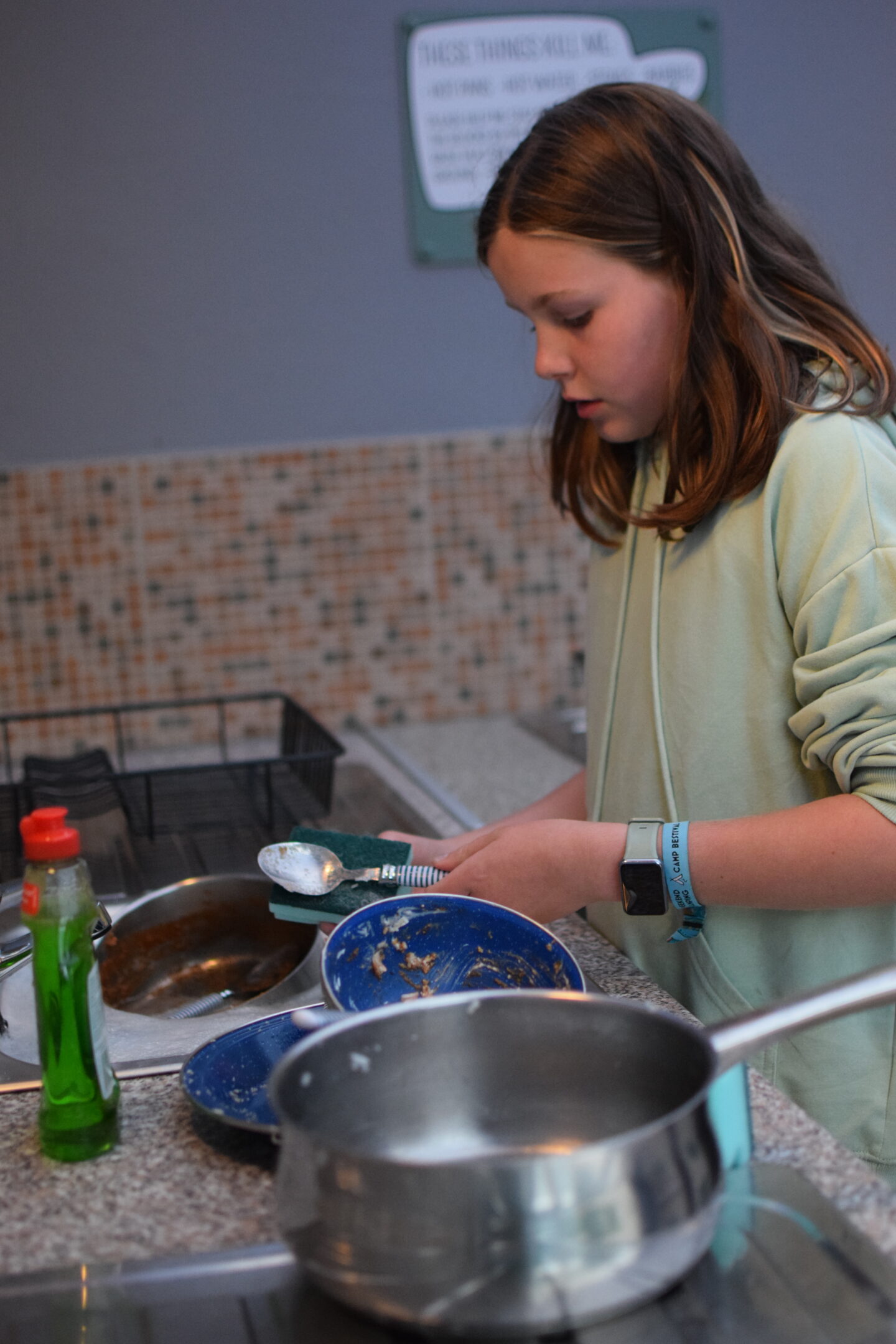 Chloe doing the washing up after dinner at the campsite